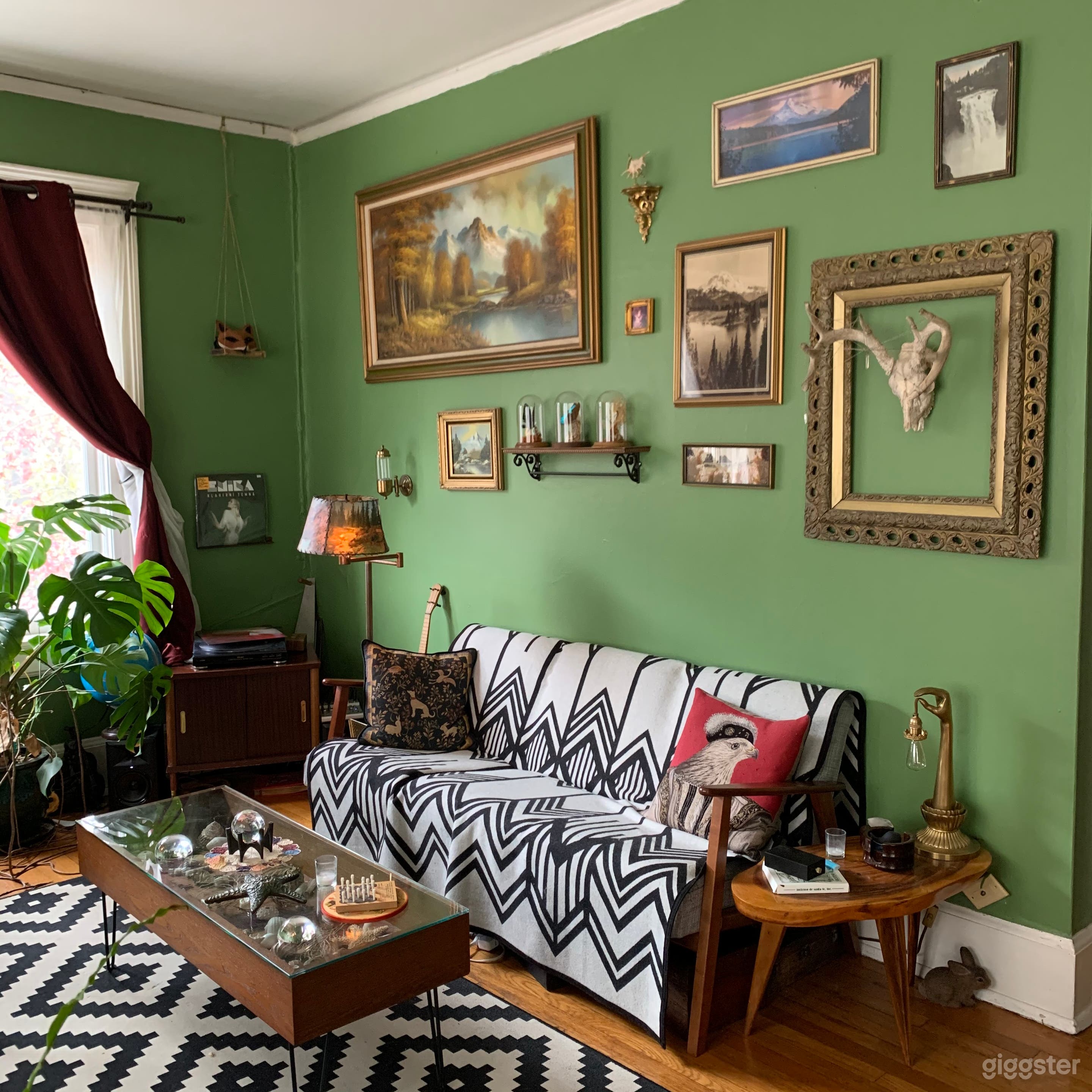 Large living room area with an eclectic salon style wall of paintings
