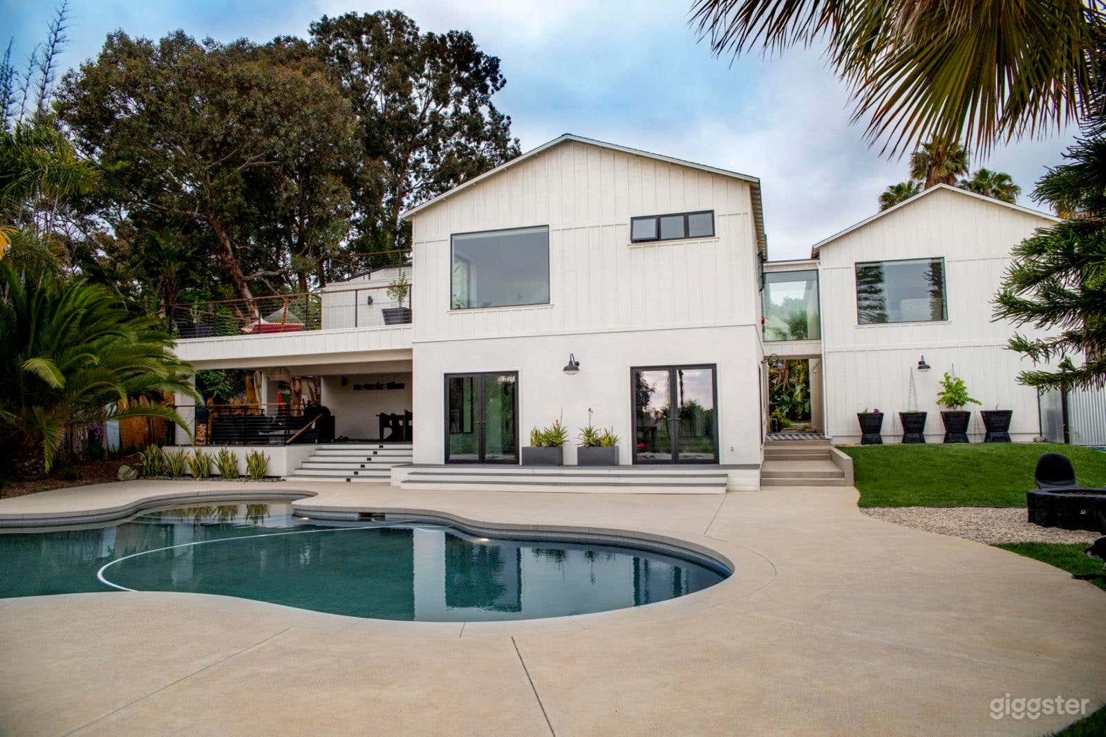 Expansive Farmhouse-Style Backyard with Pool Photo 3
