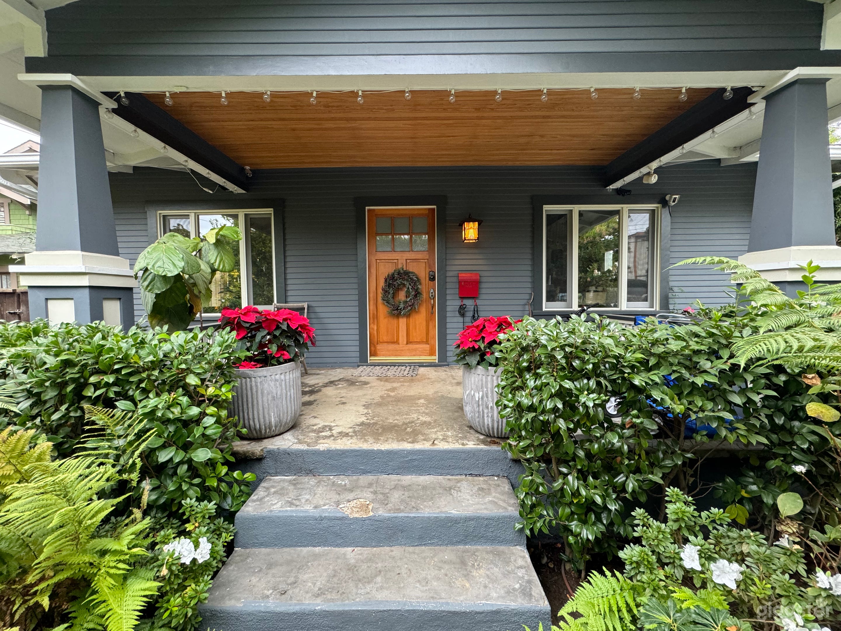 Lush landscaping in the front and back yard with mature lemon, orange, and strawberry tree, as well as planters with lavender, sage, and herbs.