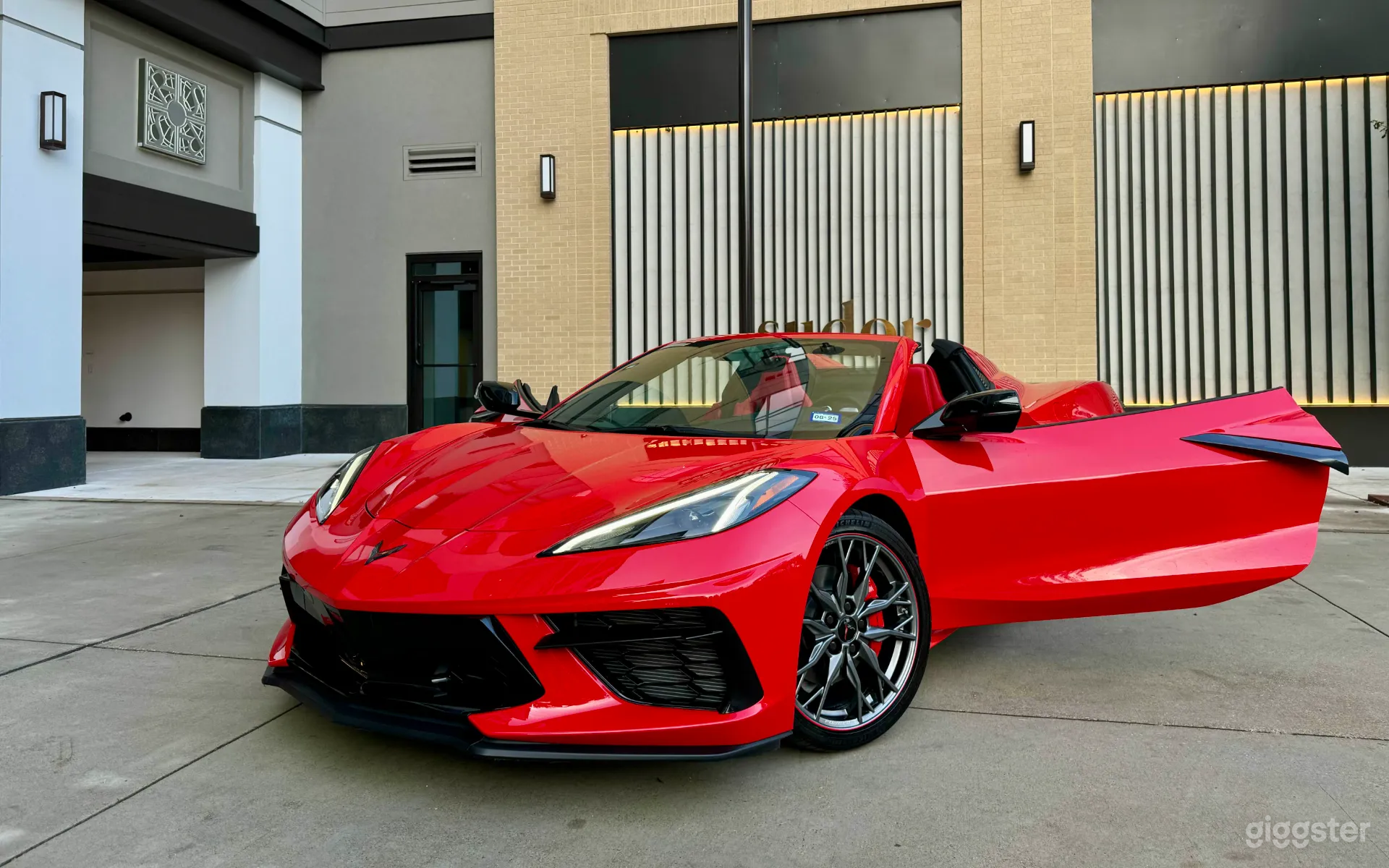 A front-angle shot of the C8 Convertible with the door open