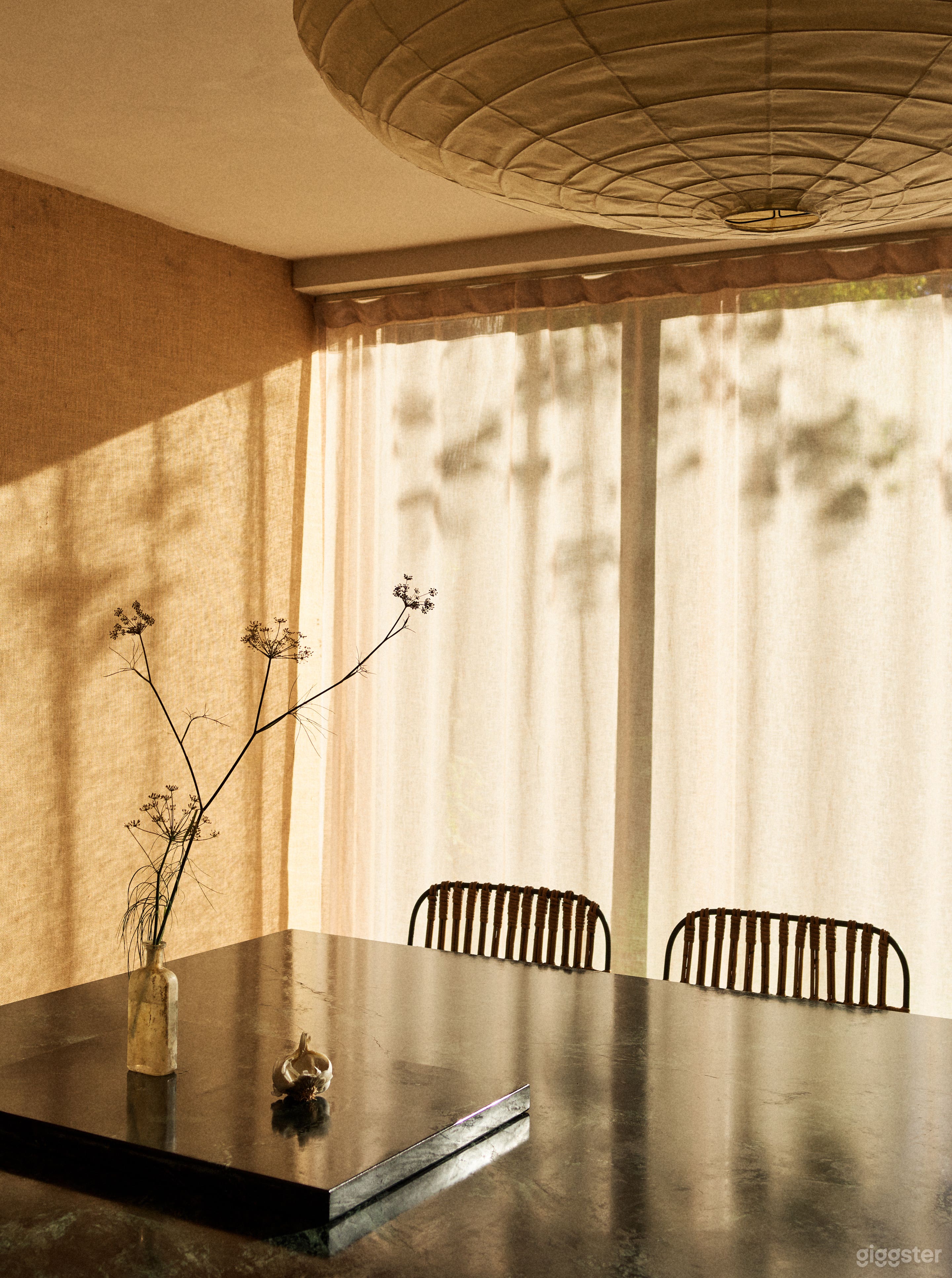 Newly designed kitchen featuring a massive green soapstone island, burlap wall coverings and an 18-foot long window overlooking green fields and trees. 