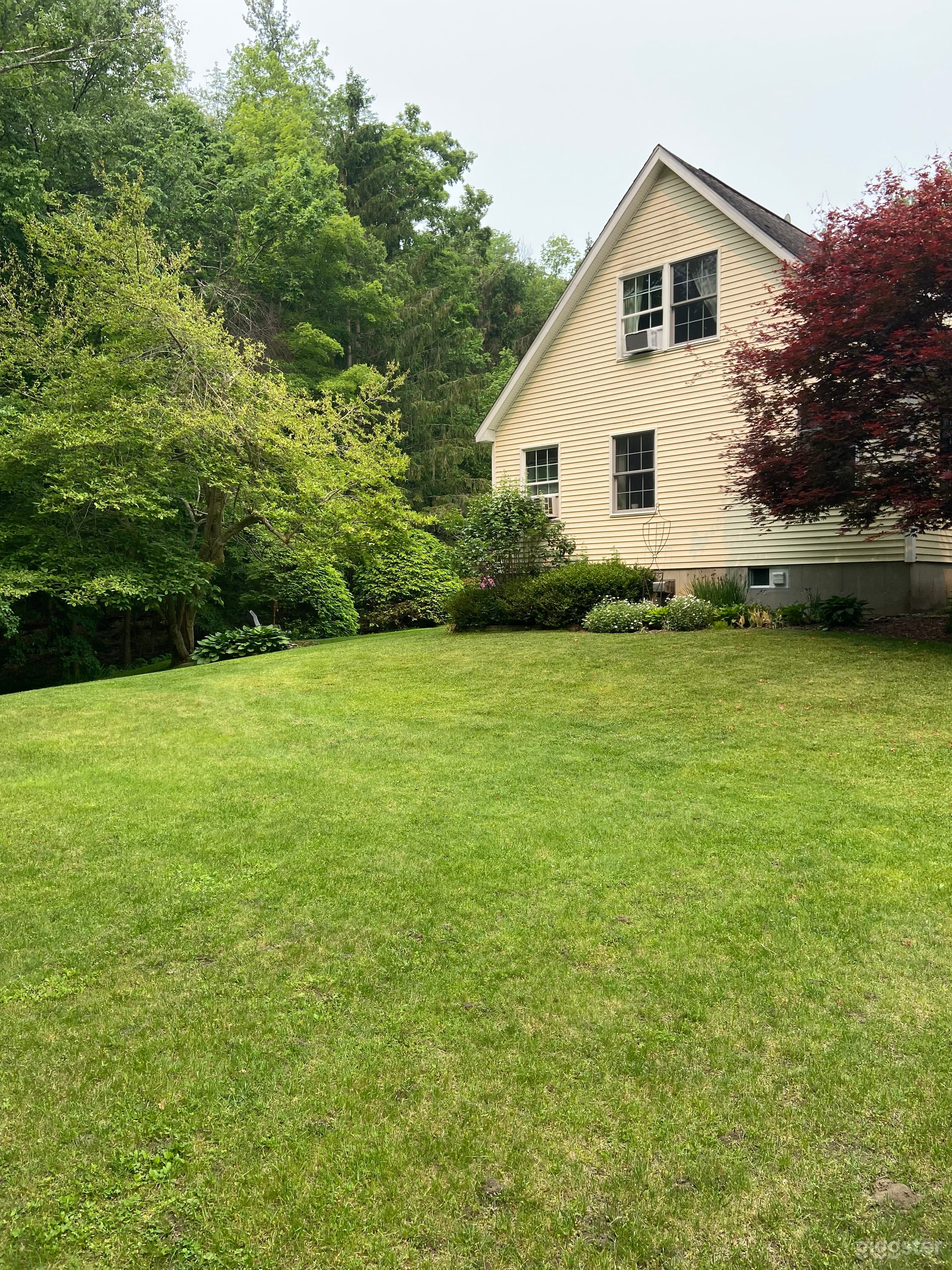 Backyard with landscaping and stream Photo 3