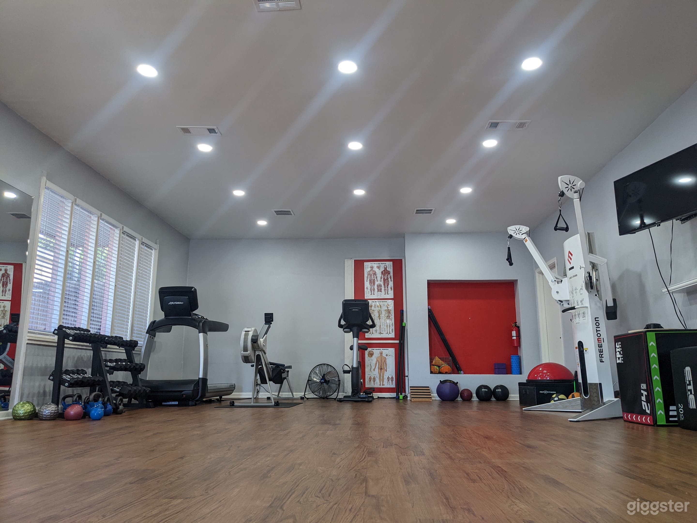 CLEAN AND WELL LIT FITNESS STUDIO WITH EQUIPMENT  Photo 1