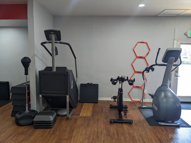  CLEAN AND WELL LIT FITNESS STUDIO WITH EQUIPMENT  