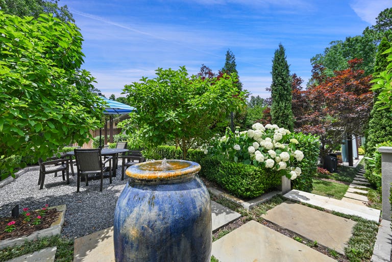  This is half of another completely separate garden room and we are looking toward the pool.  There is a fire pit with two burners powered by gas. 