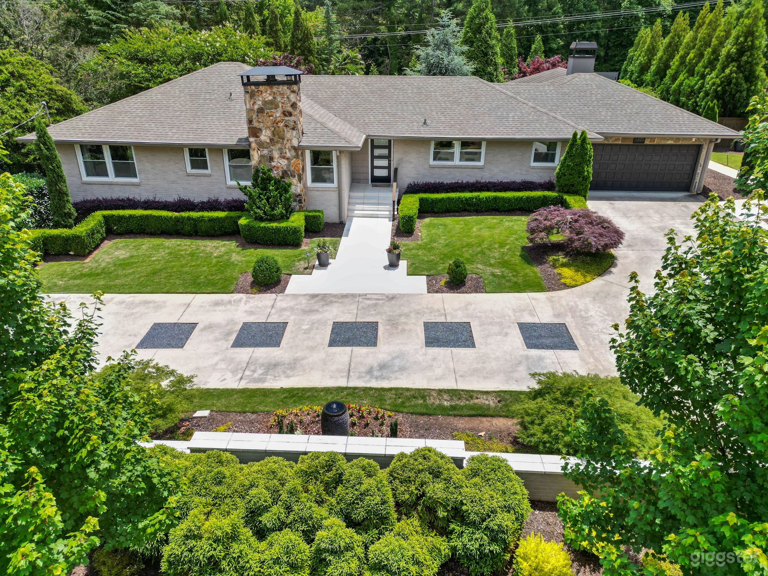 Drone photo of front of house behind the wall.  