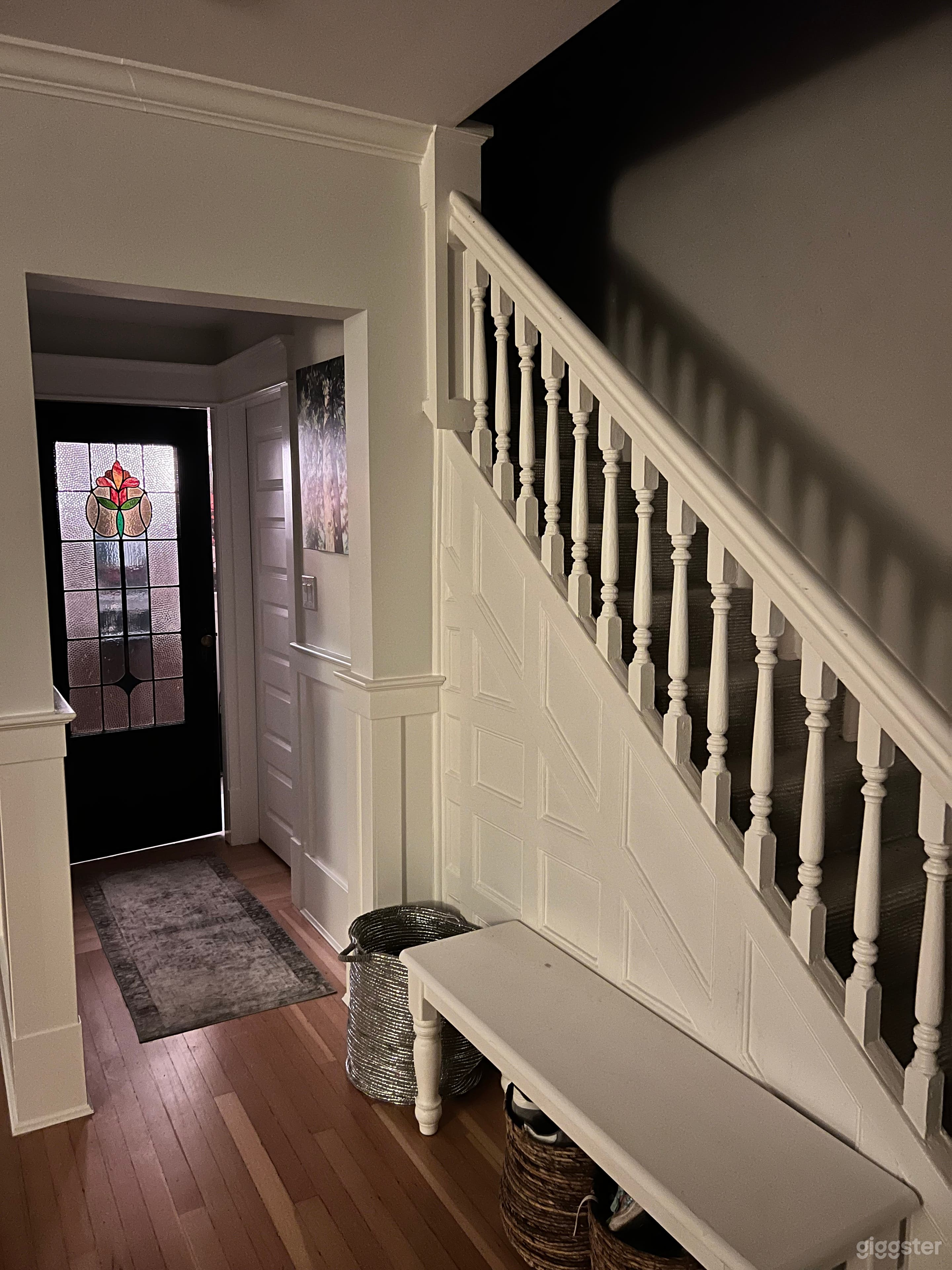 Hallway to powder room and original stairs upstairs 