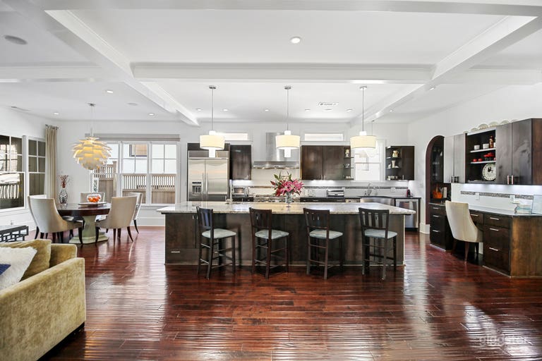  Kitchen island anchors high end kitchen and dining area 