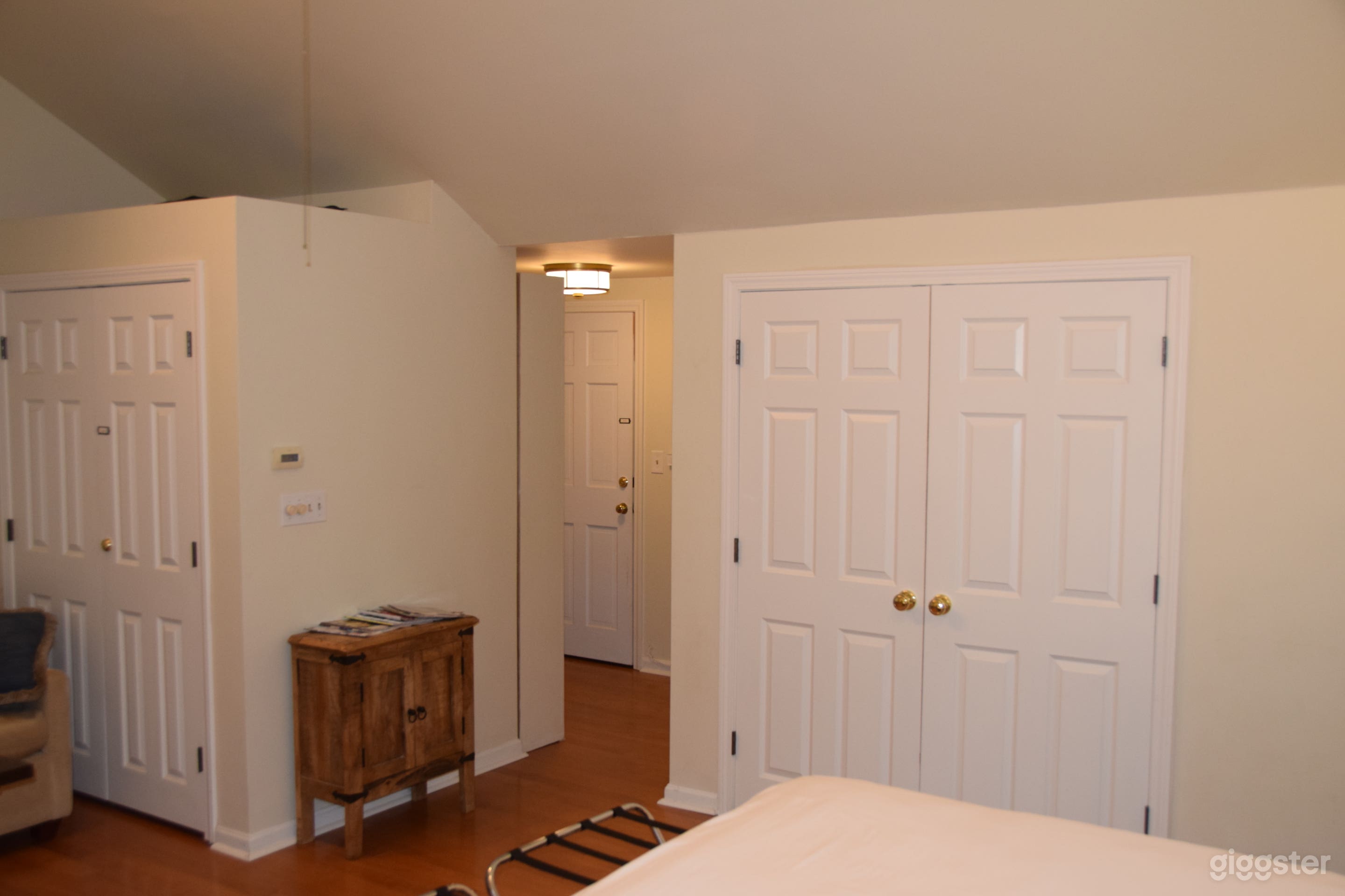 View from side of bed looking further into the house