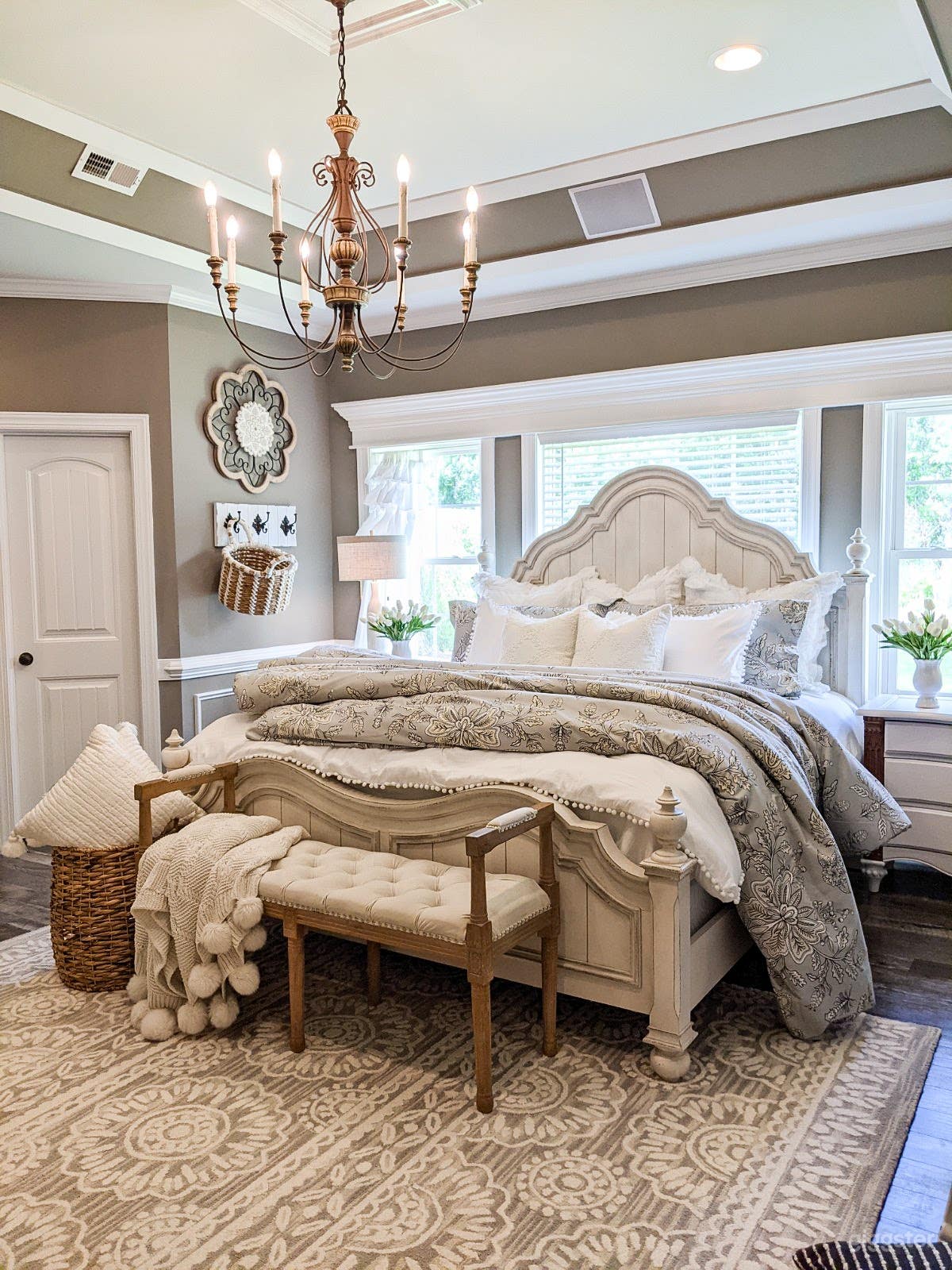 Large master bedroom with decorative ceiling. Large light fixture. Plenty of natural light. Large master bathroom. 