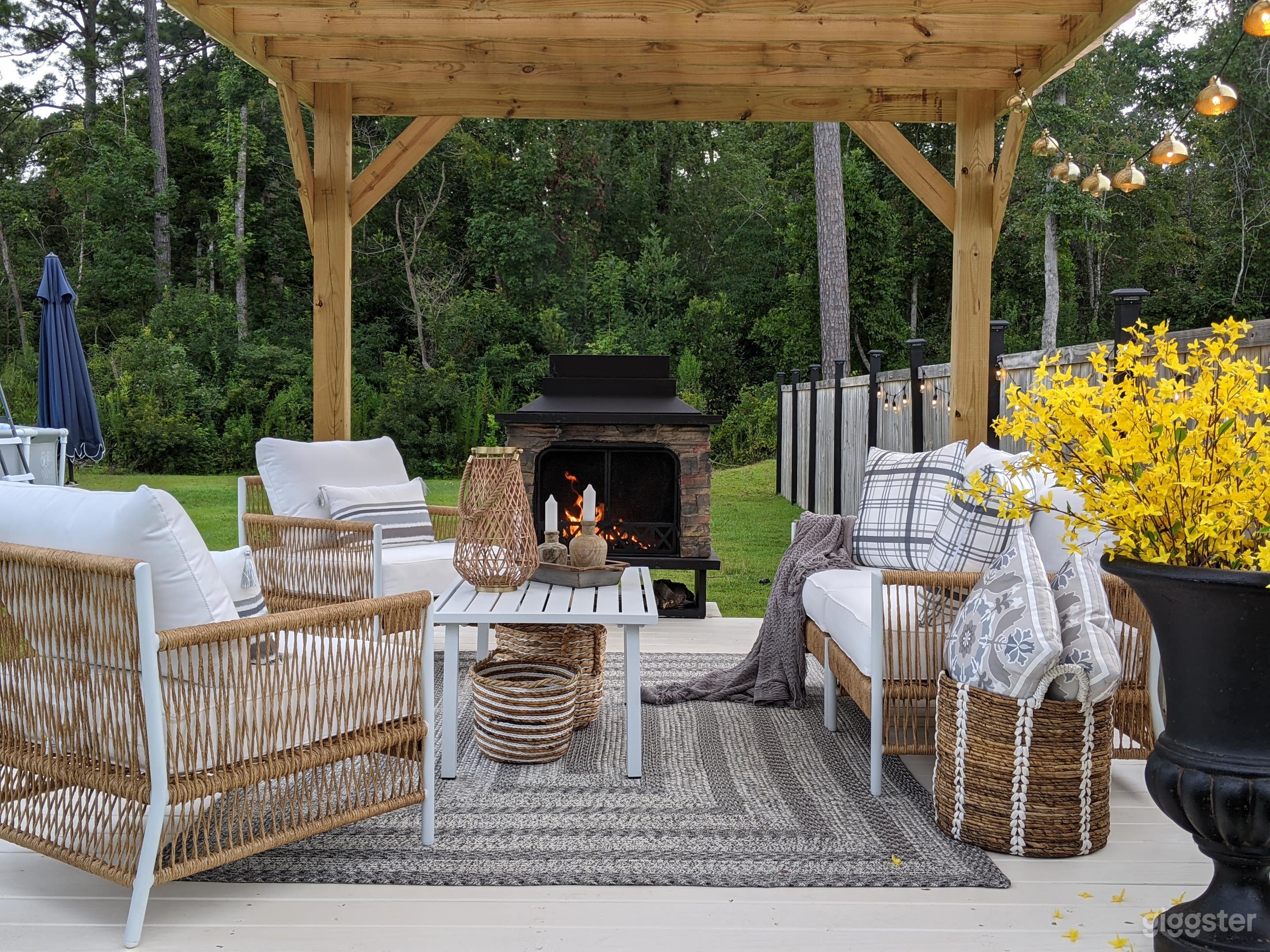 Beautiful gazebo over large wood deck with upscale furnishings and wood burning fireplace. 