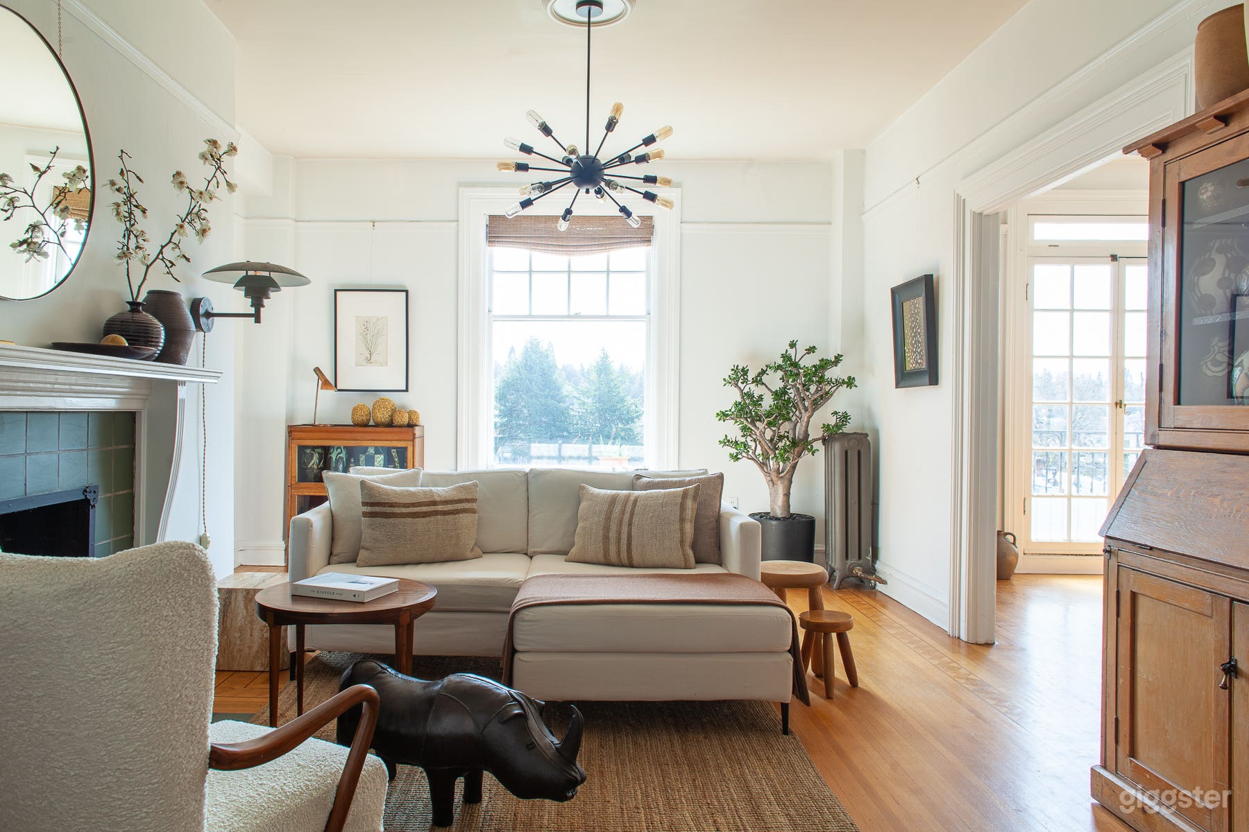 Living room with gas fireplace &amp; a unique array of live plants, art &amp; collectibles. 