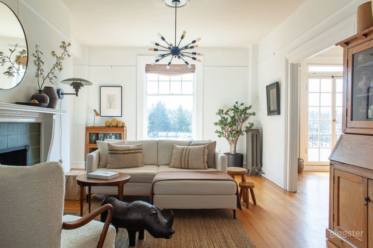  Living room with gas fireplace &amp; a unique array of live plants, art &amp; collectibles.  