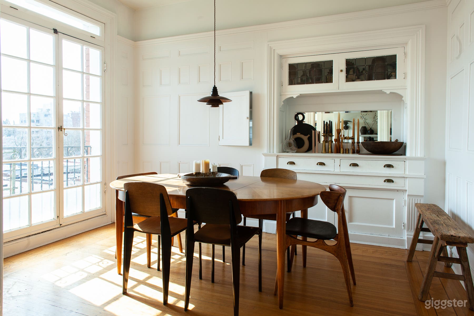 Parisian panelled dining room with a blend of mid-century &amp; rustic furnishings. 