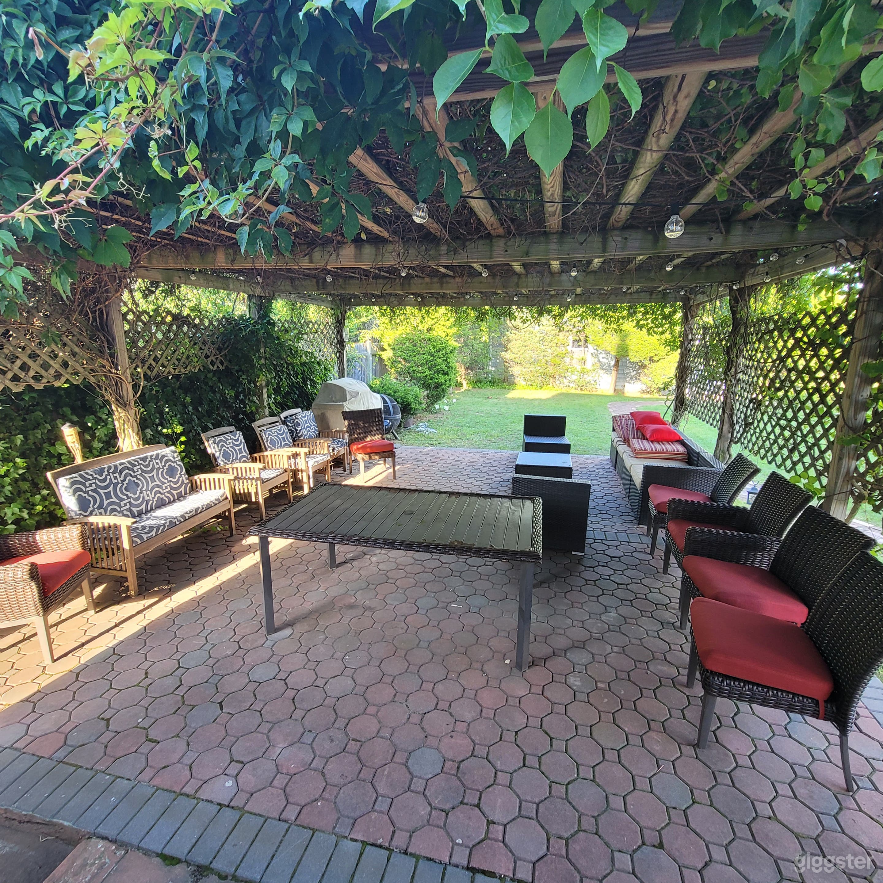 Pergola area covered in vines and has outdoor Ambiance lighting  