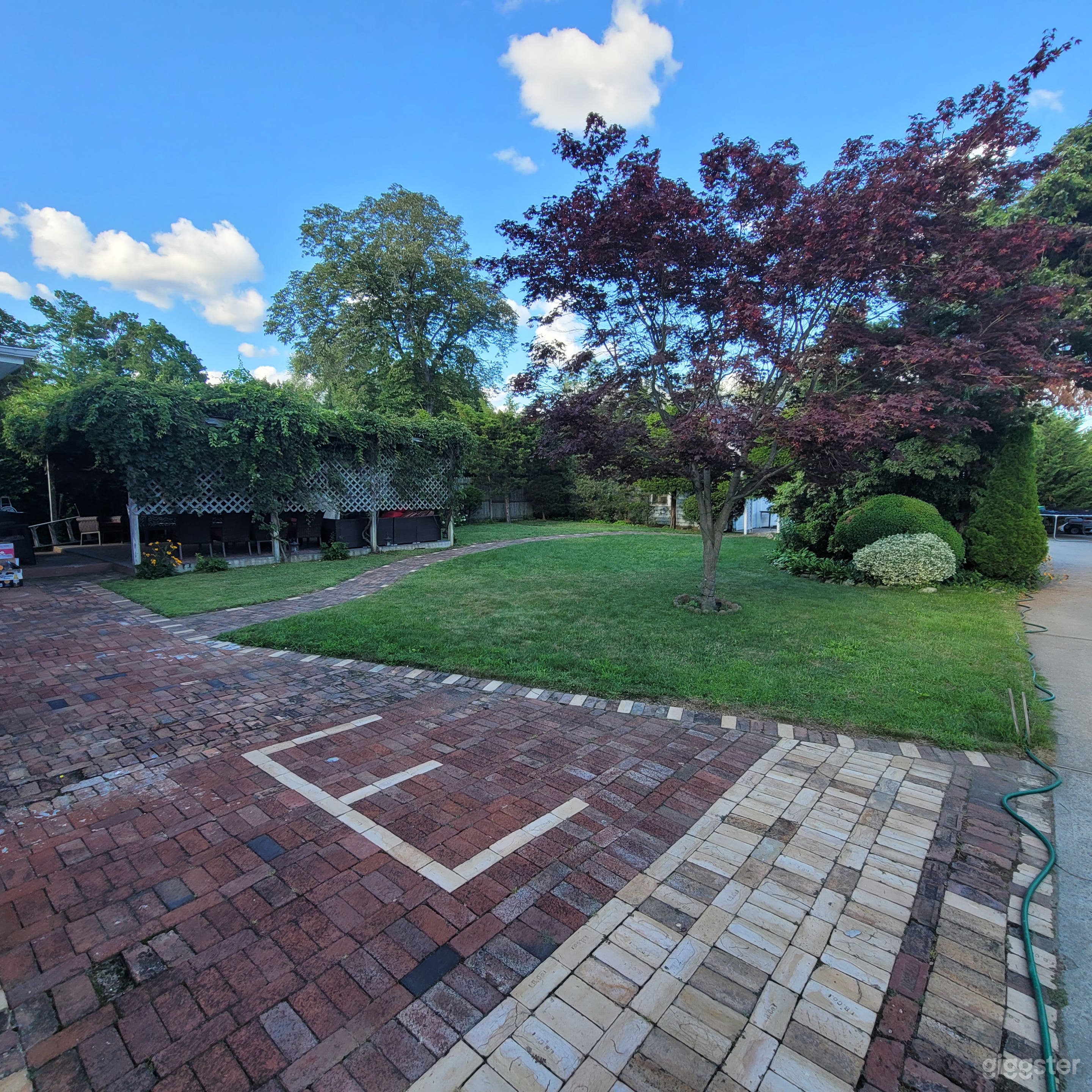 View from the driveway heading into the 1st backyard. 