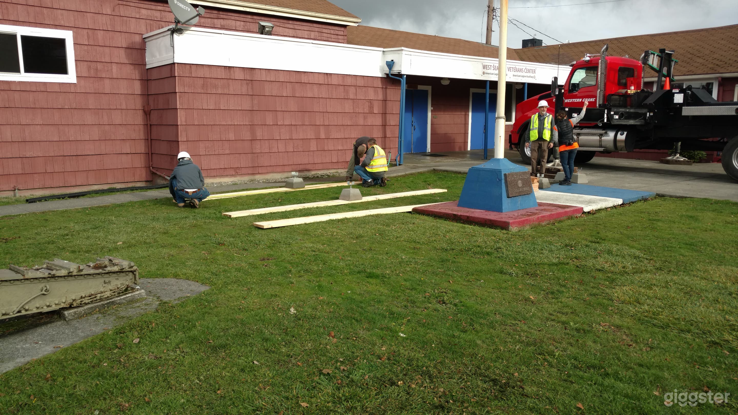 Late 1930s American Legion Hall with a flag pole and a 155mm Shore Battery Cannon in the front yard