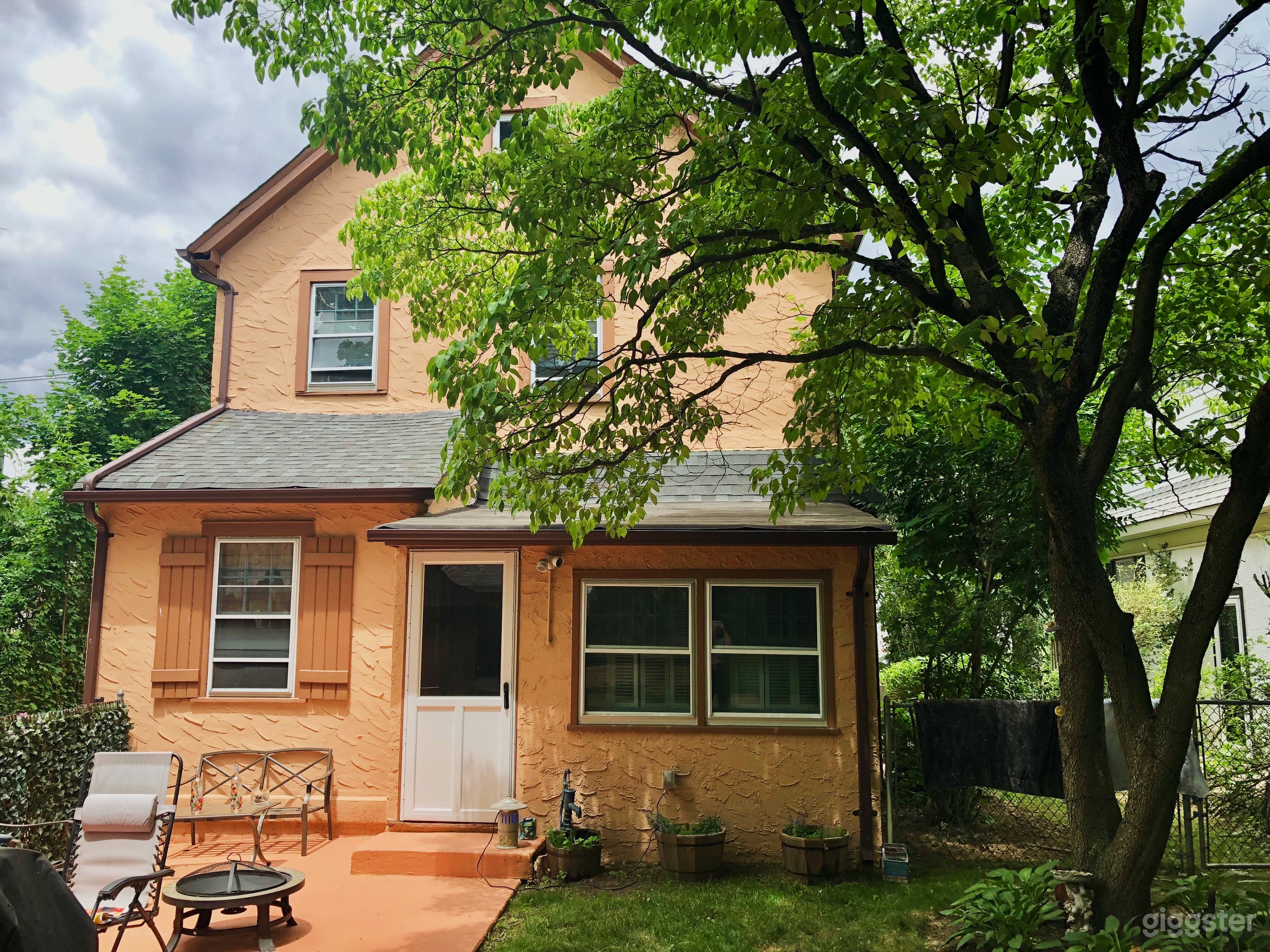 Back Yard is small but cozy. 
Sitting area on a concrete patio, 
barbeque, white washed fence,  flowers and fairy lights make a beautiful garden setting. 