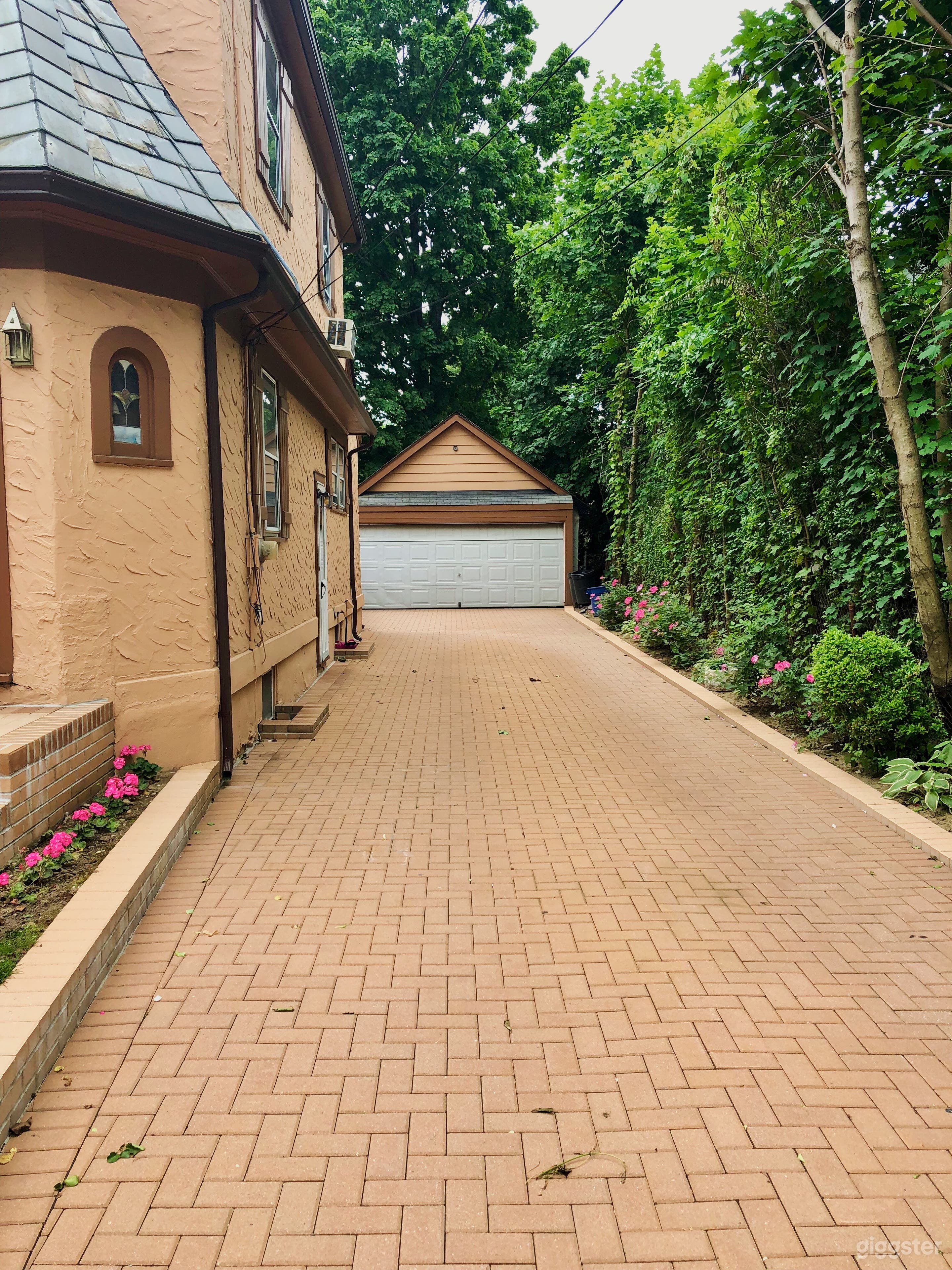 Right Side With Drive Way
Fits 4 Cars
Driveway is LIned with flowers on both sides
2 car garage at end of driveway