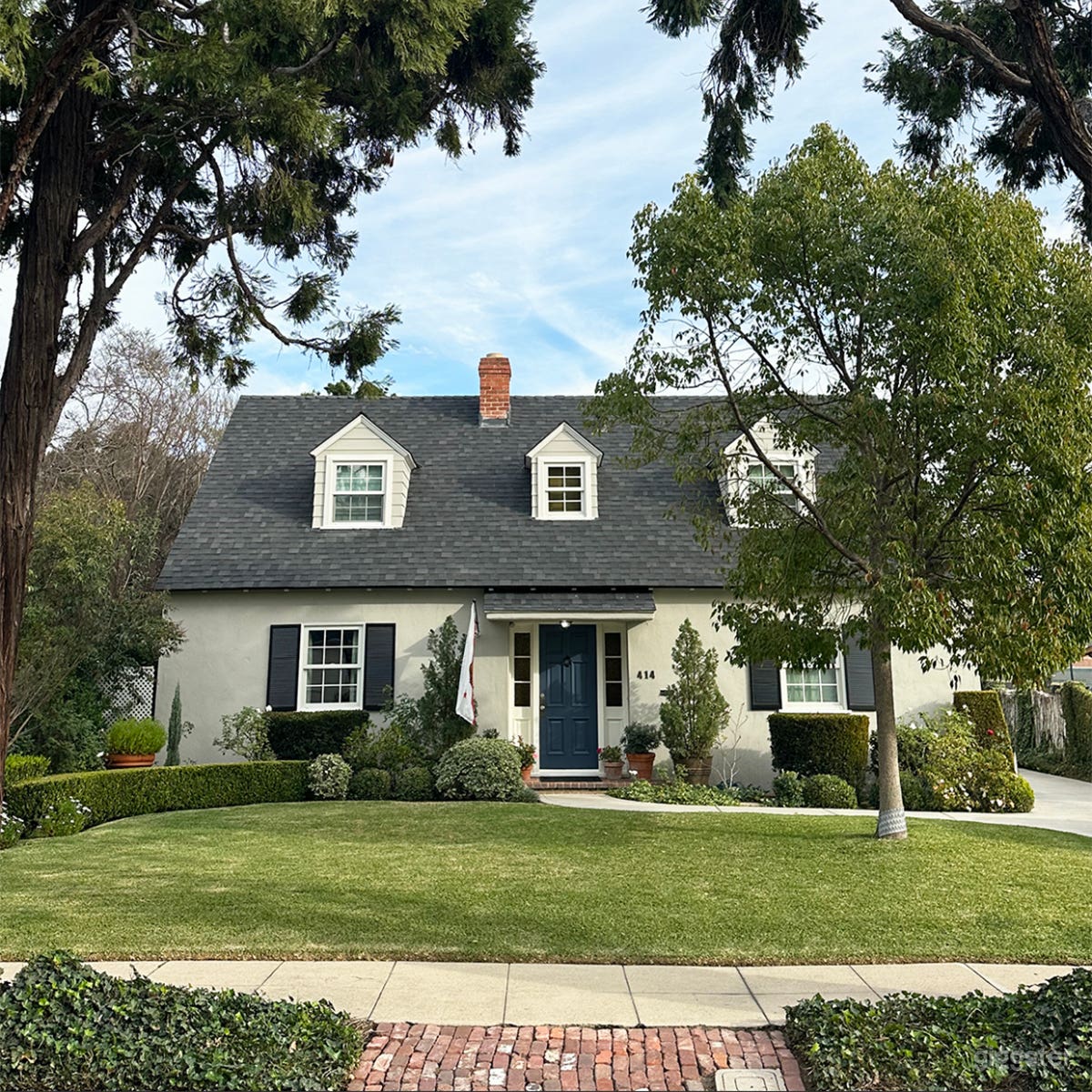 Cape Cod Style Home with Beautiful Serene Garden Photo 1