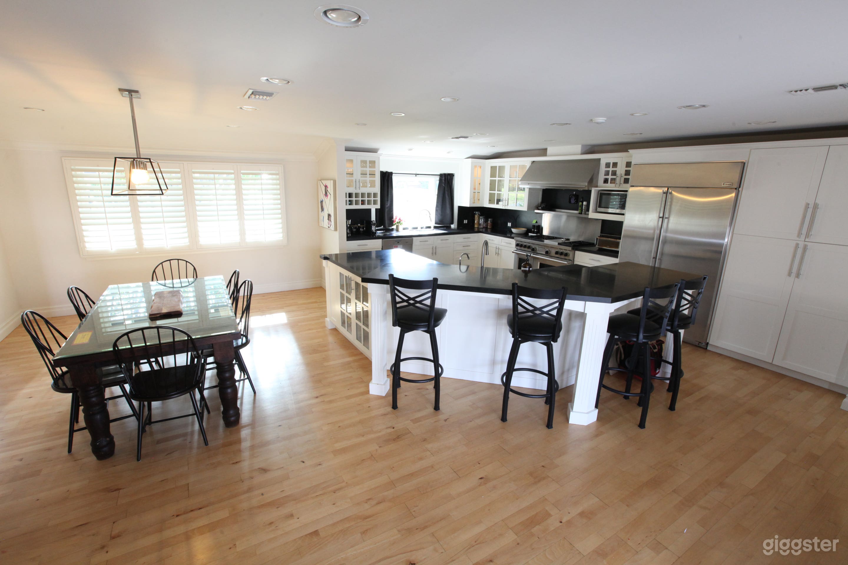 Top-of-the-line appliances (Miele, Wolf, Monogram) and expansive granite bar top. 