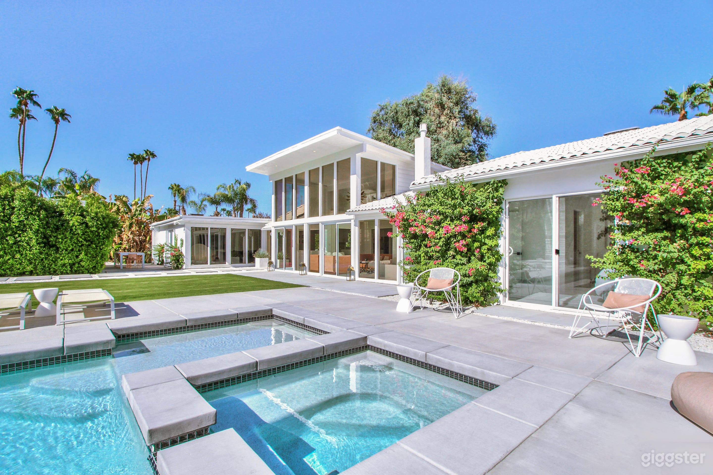 Front of home with double storey windows.