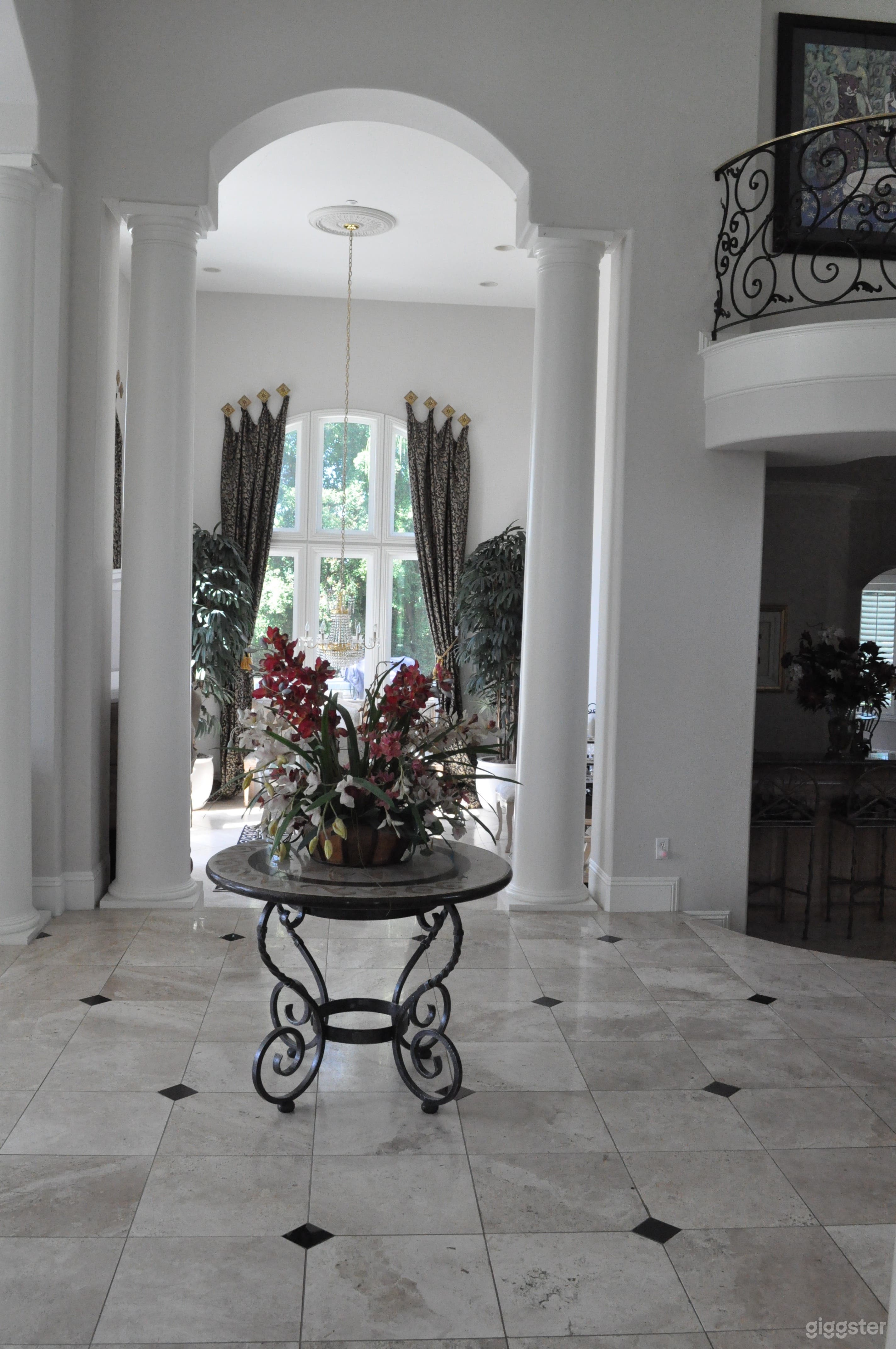 The foyer of the home which is open to the dining room, bar and living room. Its all connected