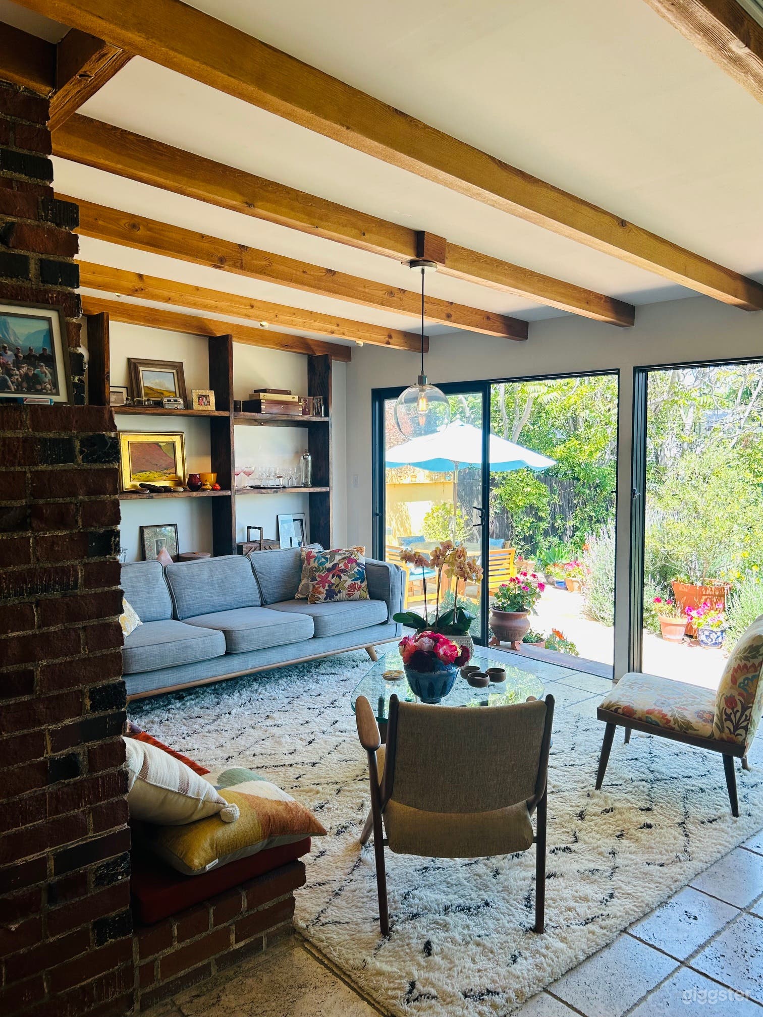 Open lounge onto backyard and pool with floor to ceiling windows