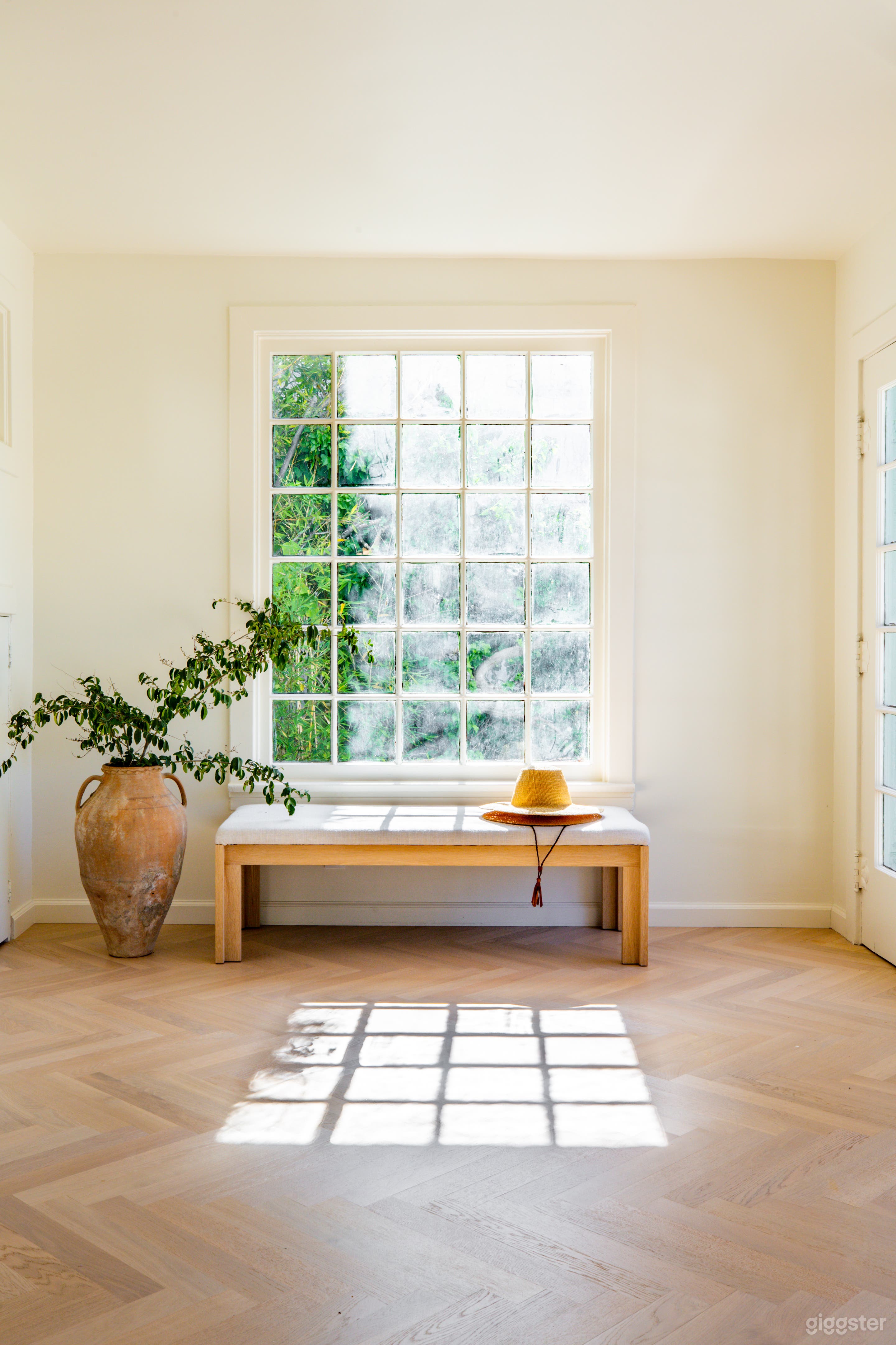 Light-filled sunroom; original 1920s windows.  White-oak Herringbone floors throughout entire home.
