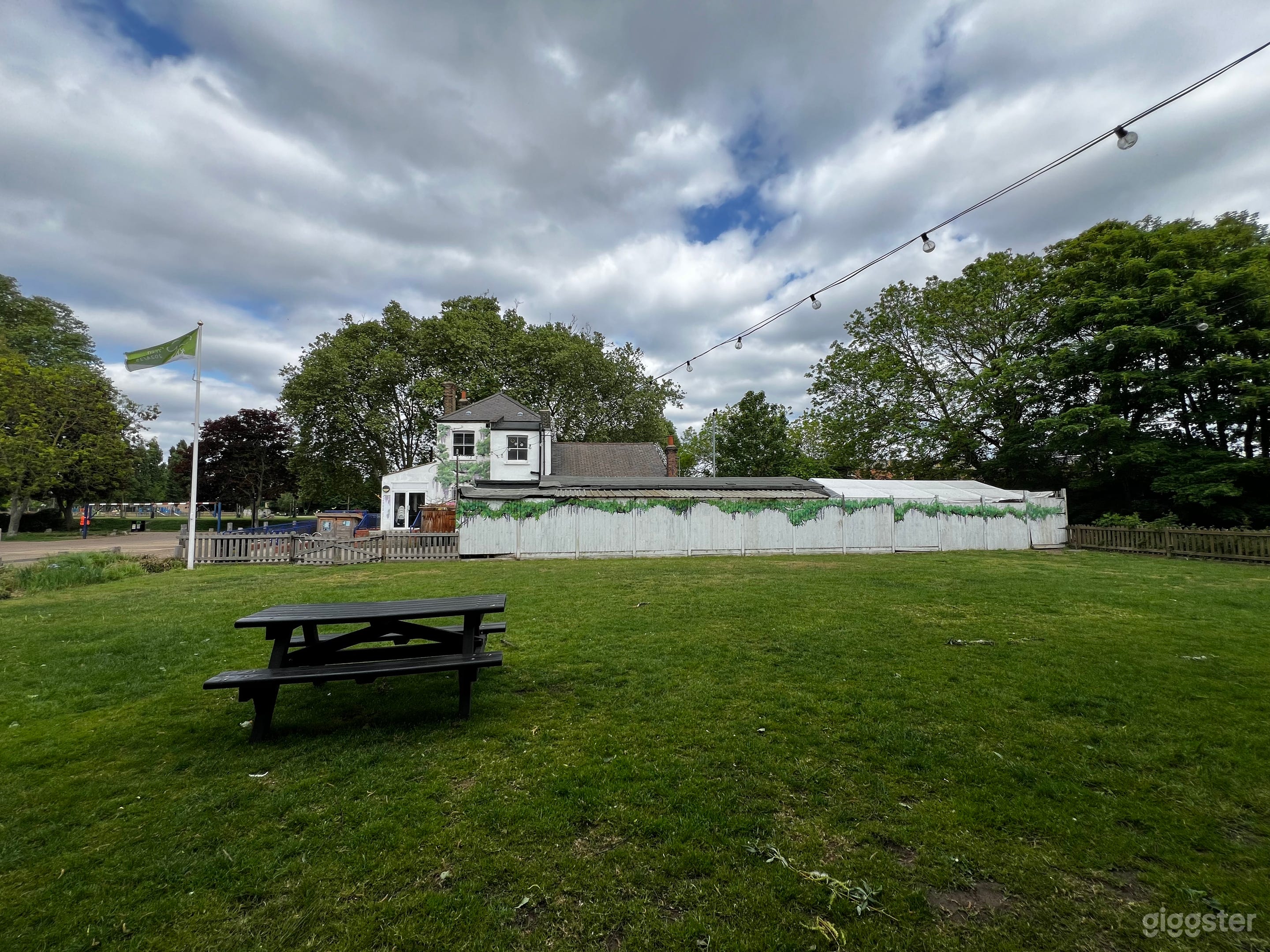 Back uncovered & enclosed lawn with 2 picnic tables