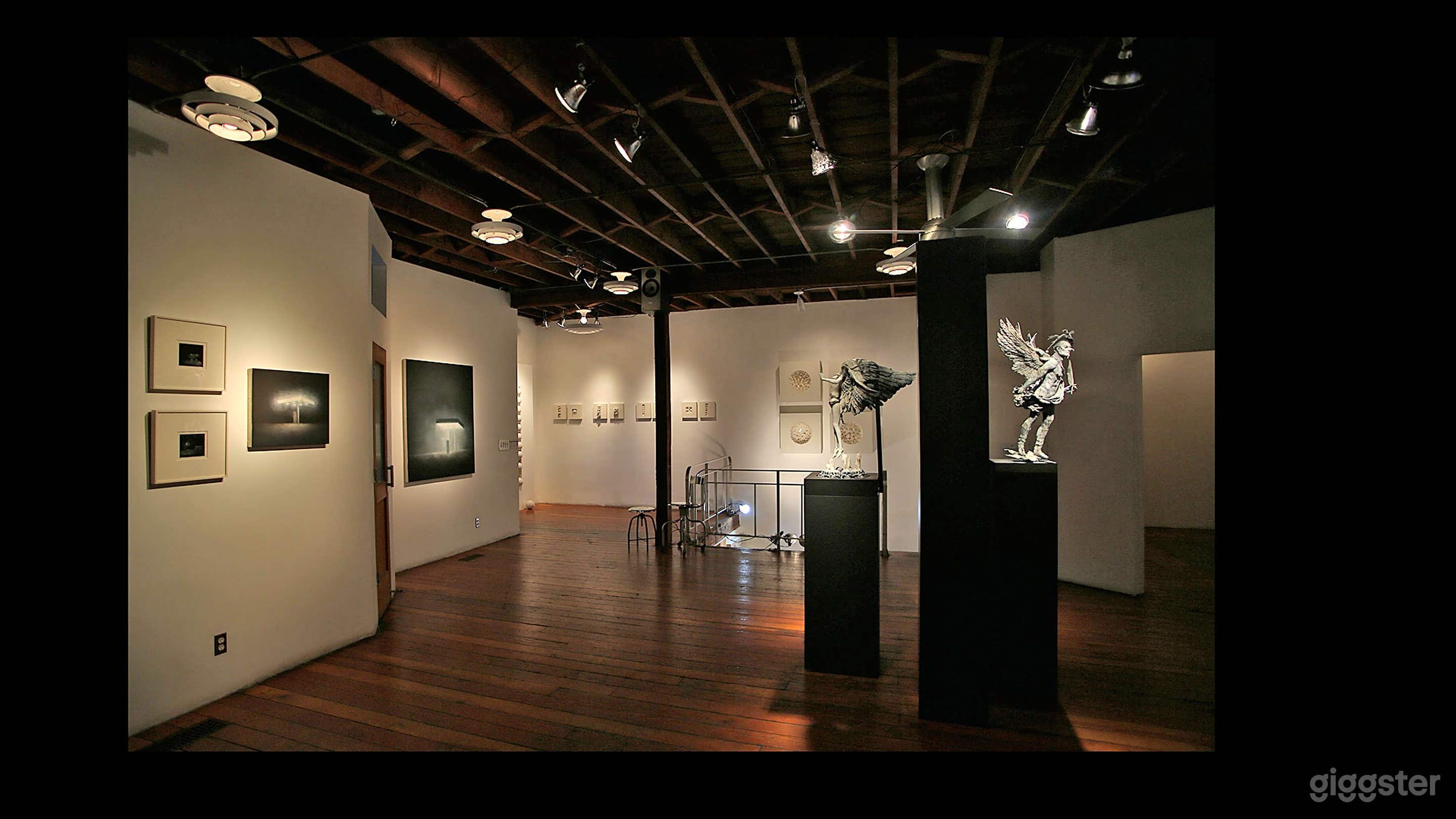 The main gallery floor: on the left is a restroom and a kitchen. On the right is a small anteroom known as the "Projects Room". 

The featured exhibition are rotated frequently and the overall aesthetics may change substantially. From pop-art to neo-classical to technologically driven works, the Loft is an ever evolving and eclectic space supercharged with creative energy. 

The acoustics are phenomenal and we've hosted intimate performances from top recording artists to experimental sound installations.