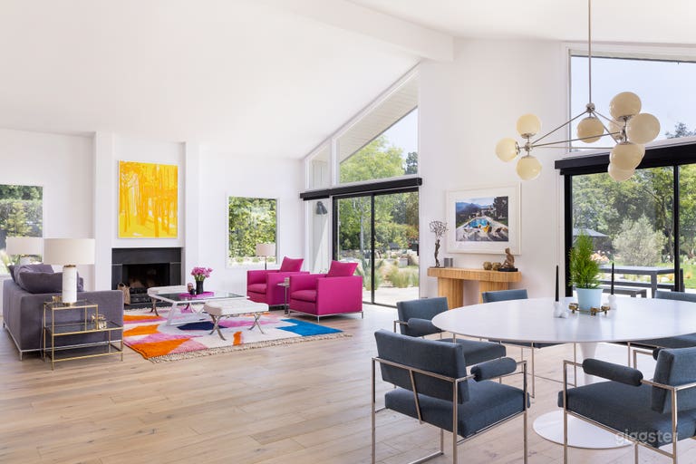  Main living area off of the large kitchen sits Milo Baughman chairs and a large Eero Saarinen marble table with seating for 8+. Additional outdoor dining and pool are steps away. 