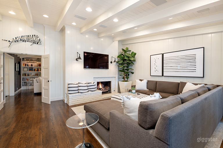  Family room has a large sectional, fireplace, vaulted ceilings and a dining table 