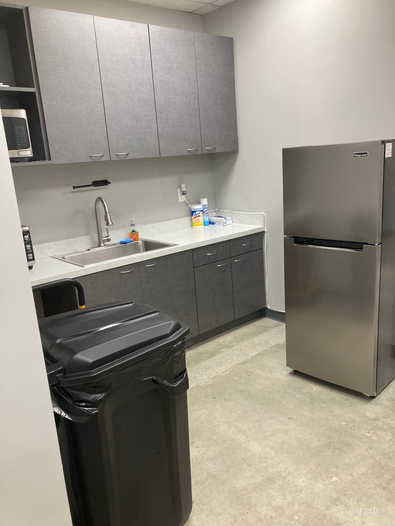  Kitchen prep area with sink, refrigerator, warming oven, and microwave 