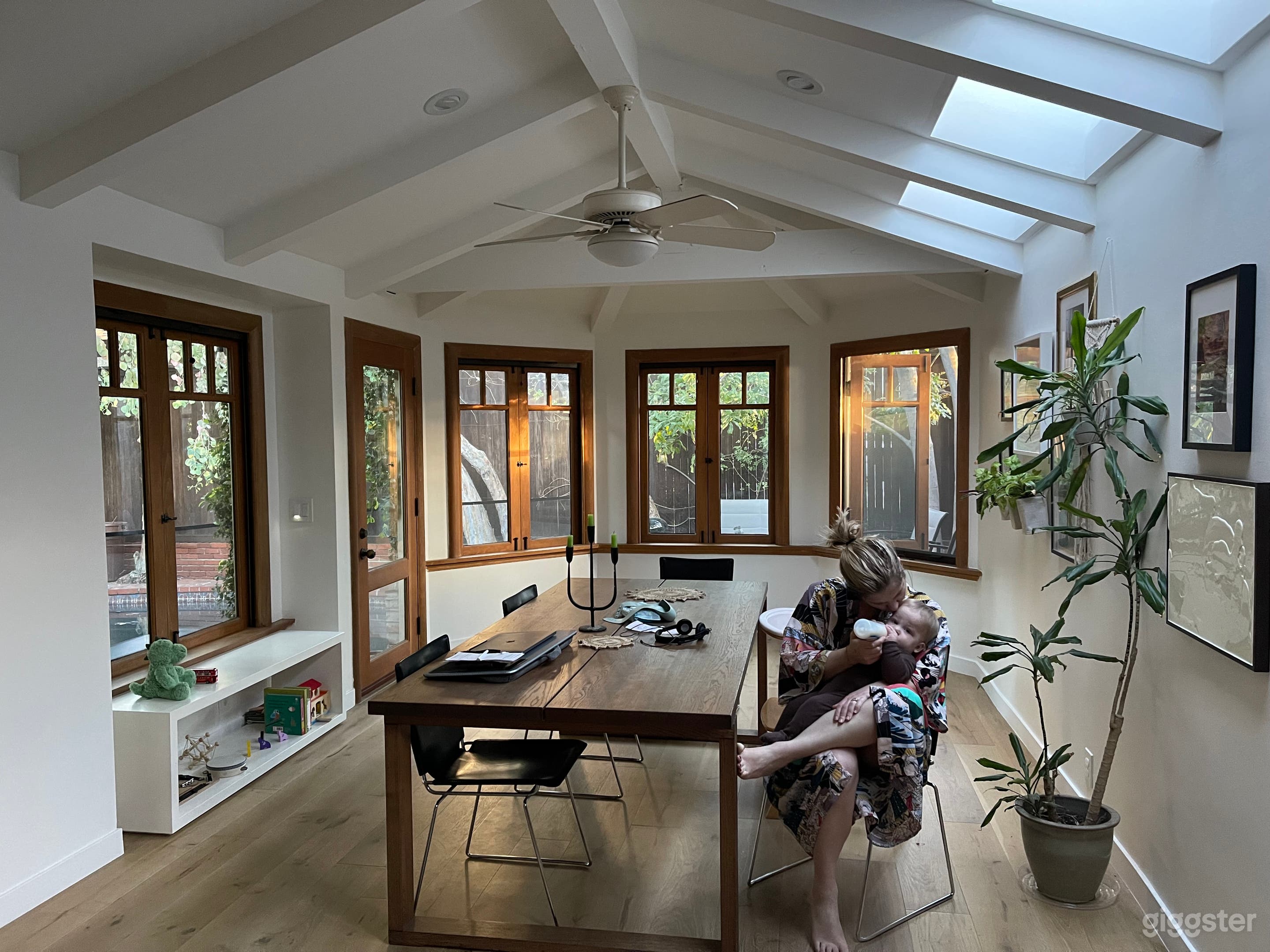 Dining room with two entry points, three skylights, windows, exposed beams, pitched ceiling and lots and lots of light. 