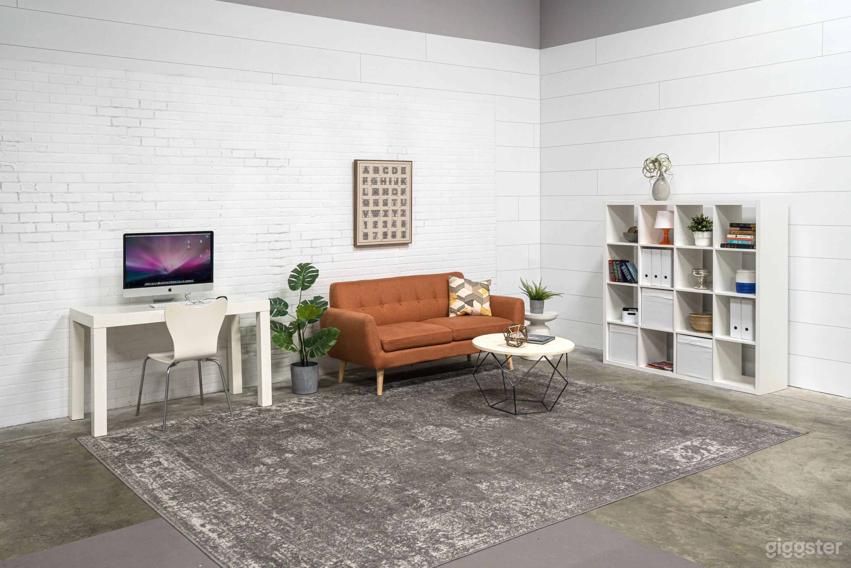 We have a "loft-like" room set in one corner of the studio.  The wall in this part of the studio is a white painted "faux-brick" which adds a nice background texture. Use of the set/furniture comes with the studio rental.