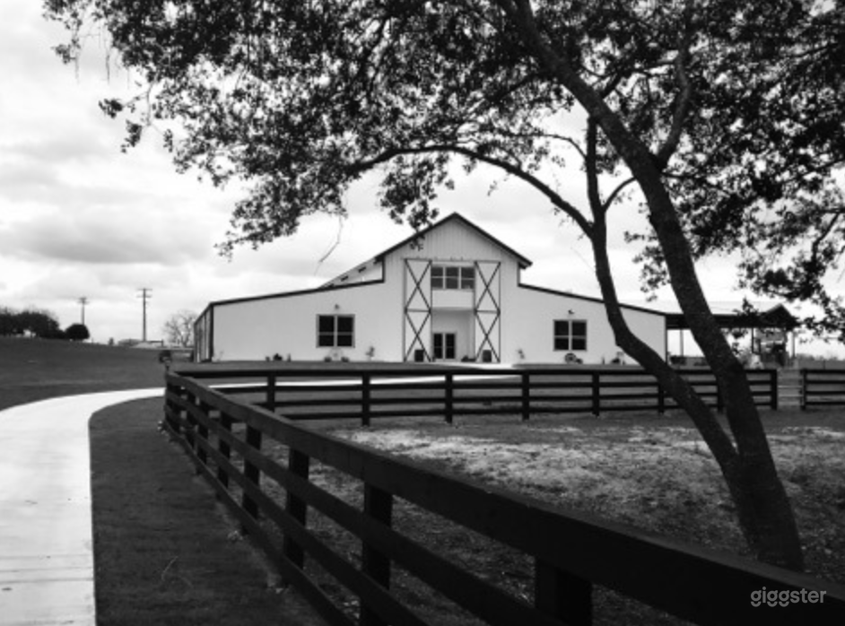 Exterior of the main event space. From parking areas to main building there is a creek bridge with pond and creek views. Very private and quiet with impressive sunset views and neighboring hills. 