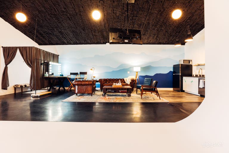  Wardrobe, hair and makeup area with wardrobe rack, client viewing lounge with tv hanging from ceiling with Apple TV, and kitchen area. 