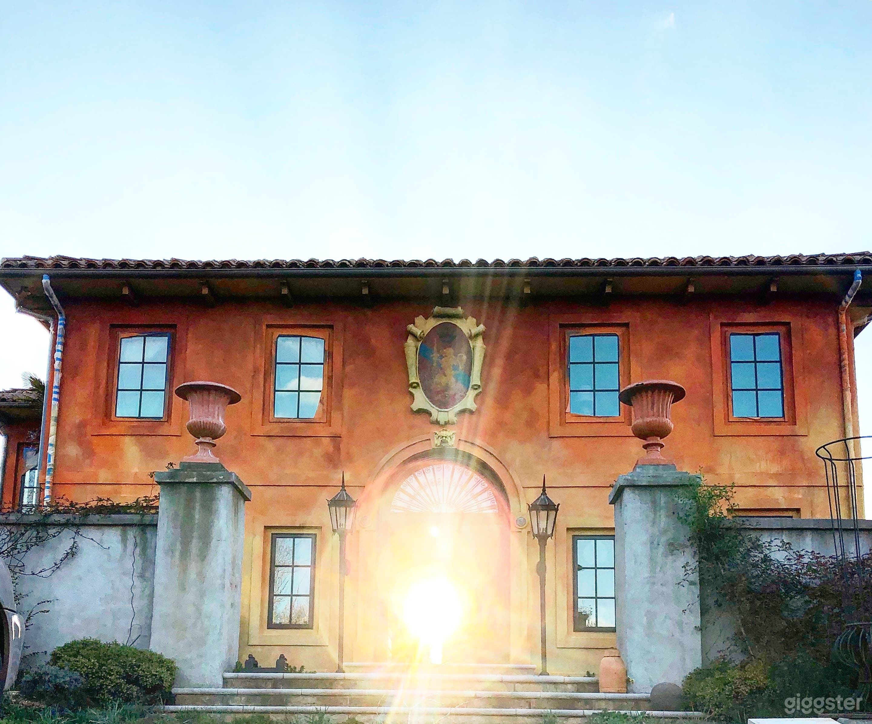 Front of the Villa washed in historic terracotta colored lime wash.