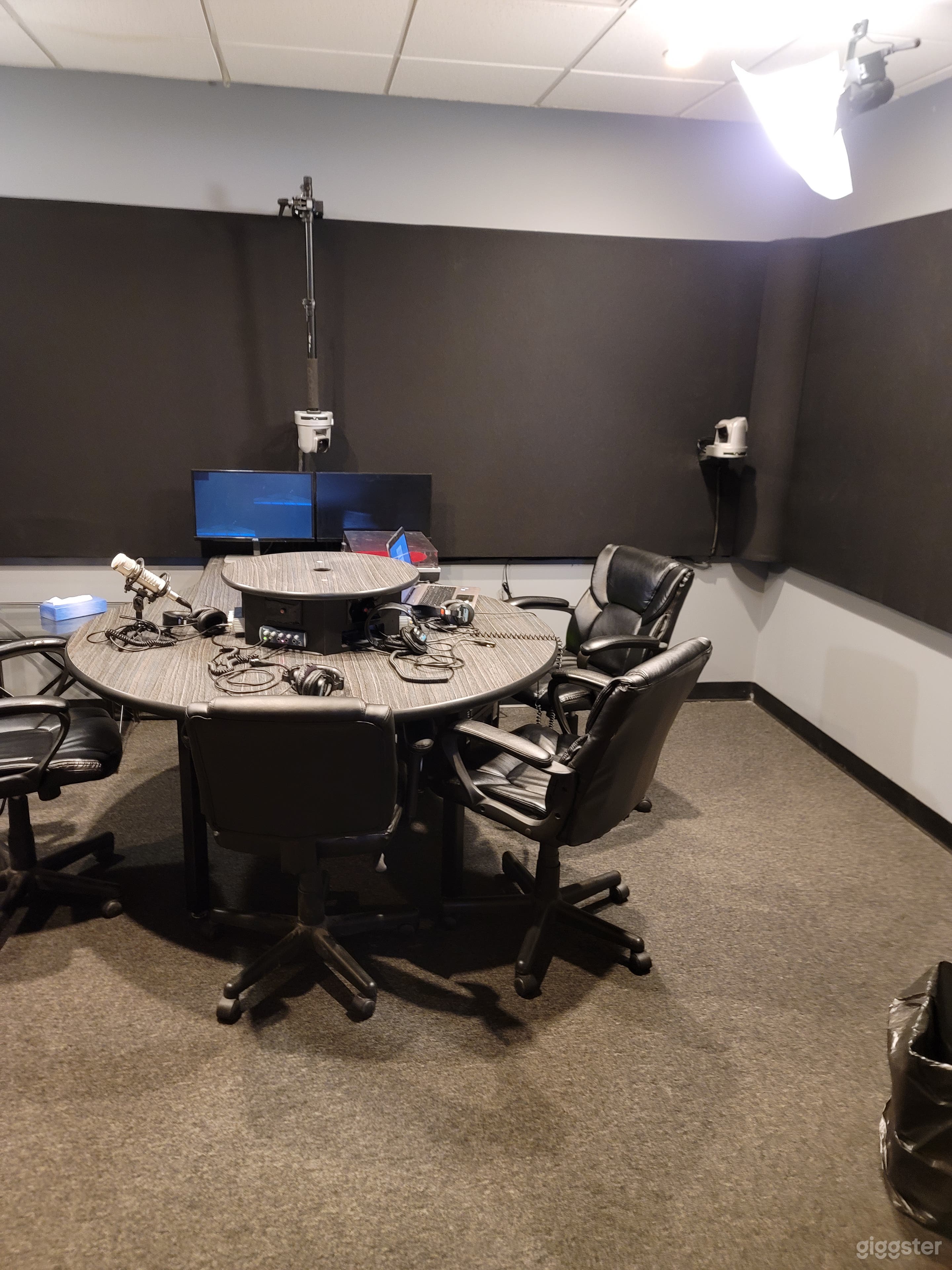 Studio A - small ensemble sound proof space. Shown with Podcast style interview desk.