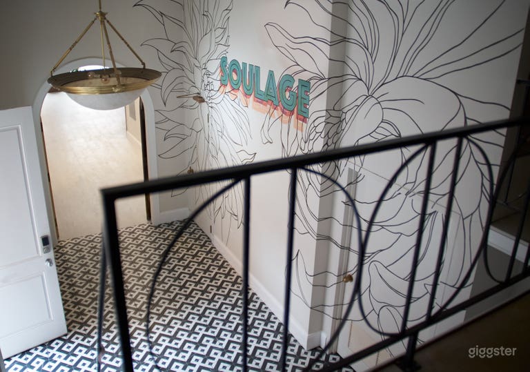  A view from the mezzanine of the lobby area. There is currently a beautiful hand built desk in front of the mural. 