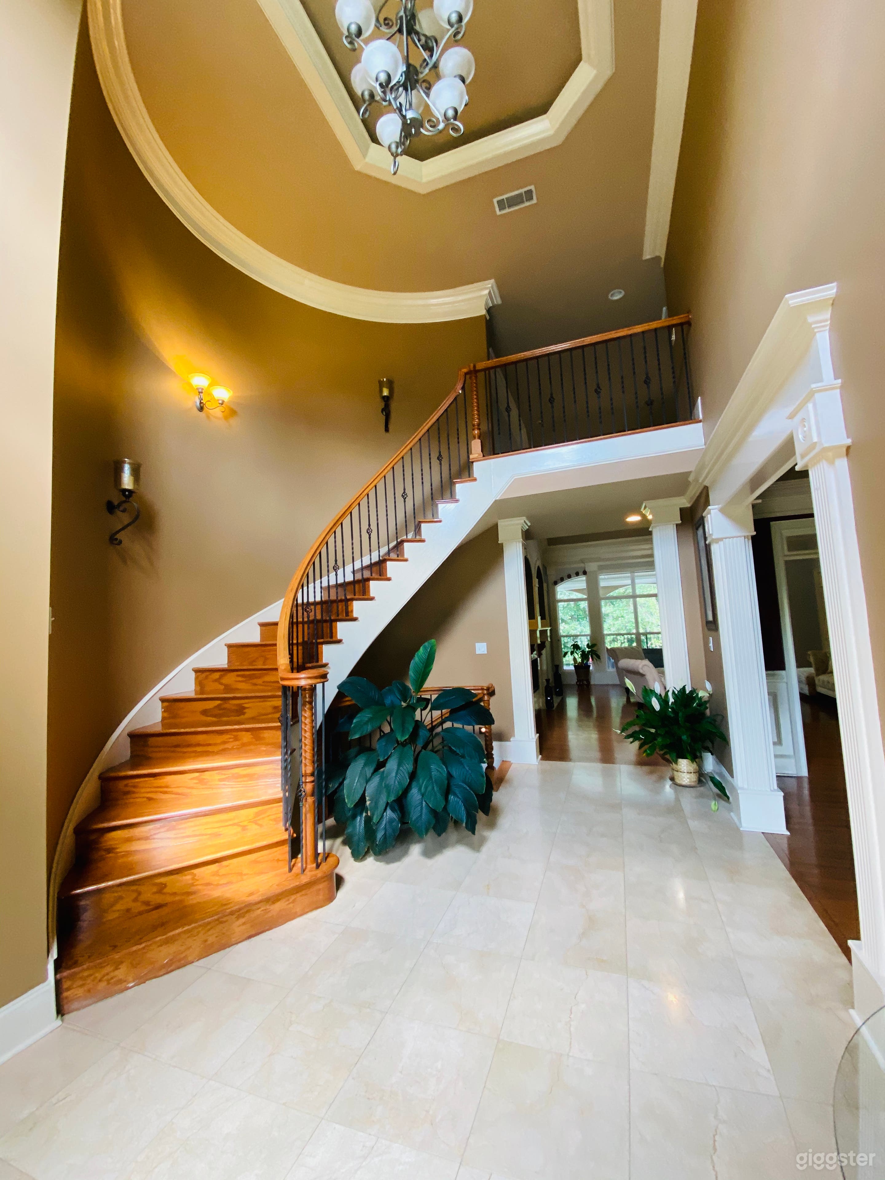 Foyer with an open view of the upper level, dining room and family room. 