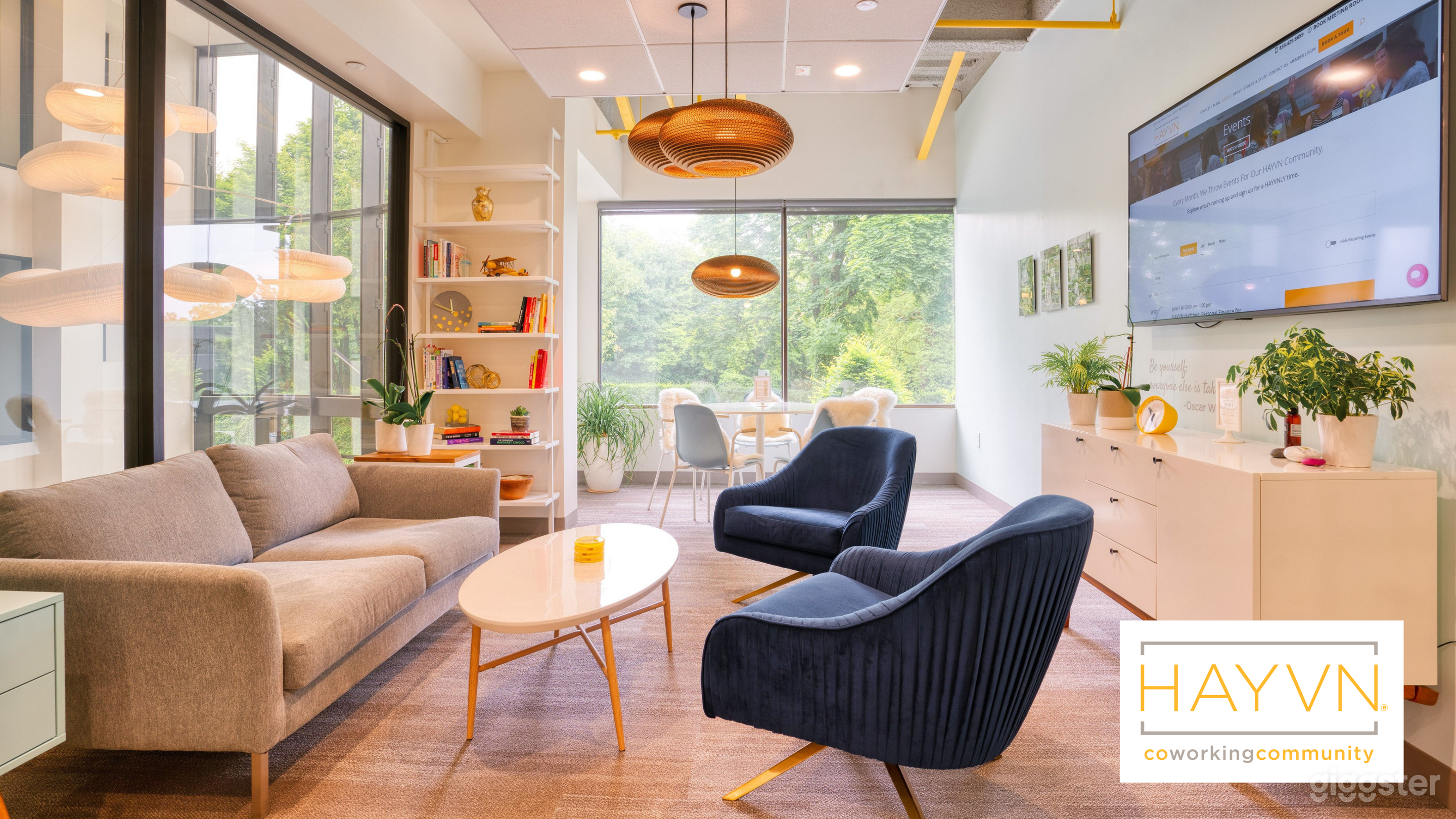 The seating is oriented toward the HD flat-screen TV, making this setup perfect for slide decks, virtual meetings, video calls, or client presentations. A professional yet relaxed environment for focused work.