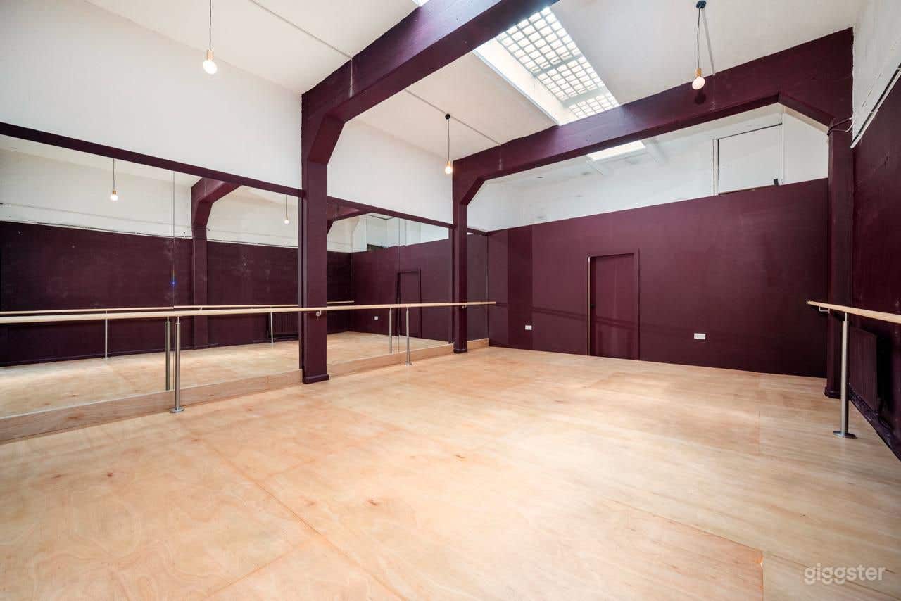 Versatile Dance Studio with Mirrored Wall and Barre Rail Photo 1