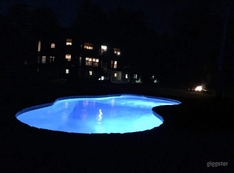 Relaxing Swimming Pool with Manicured Yard Photo 2