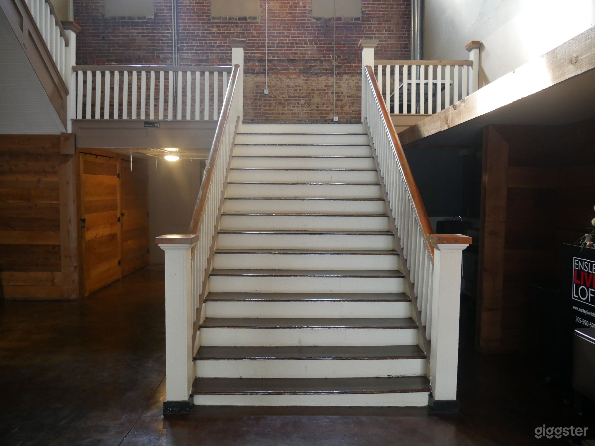 Live Loft dramatic southern charm staircase with exposed brick walls