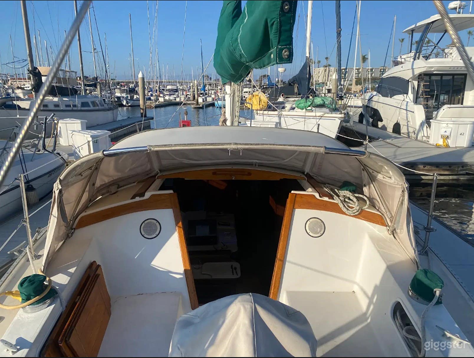 Cockpit looking forward. Window covers can be removed from dodger and and the Helm ( wheel steering)