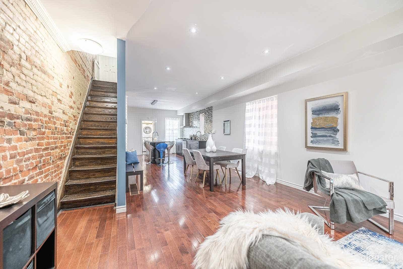 Main Floor that has a large brick wall. Modern kitchen. The blue wall is now white! the kitchen backsplash is also now white.