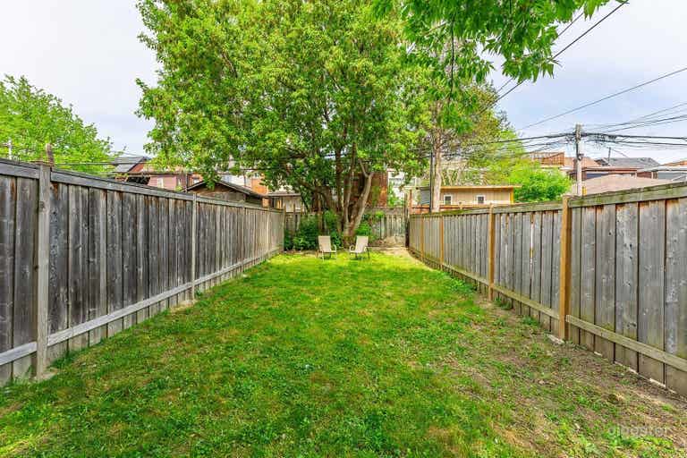  Huge backyard! Blank canvas for any production needs. In the warm months there is a thin garden around the perimeter with beautiful peonies, tulips, hydrangea, dahlias, and more green grass throughout. 