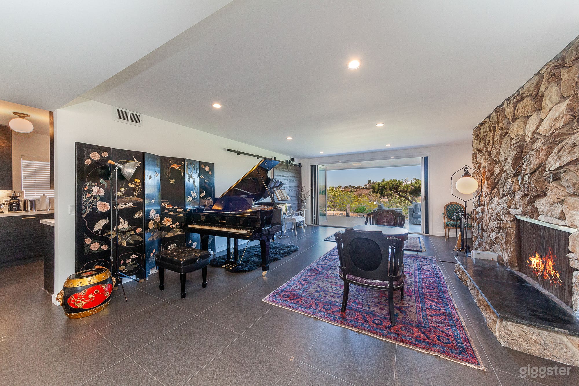 Living room features Kawai grand piano and fireplace.